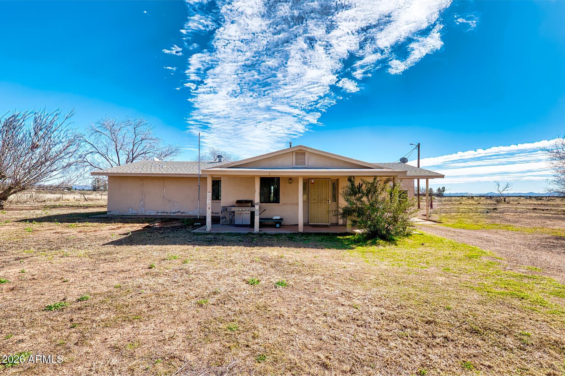 Beautiful Updated Home with a Private Well, nearly 2 Acres of Land and a Very Large Great Room! This home has lots of options. It is large for a 2 bedroom home, has an extra Arizona Room and a Very Large Kitchen. Lots of Land to use as a small farm or just enjoy as a Great Country Home! This is the Best or rural living. Far enough out of town to enjoy our amazing Arizona Skies and lots of elbow room, yet close enough to get to shopping, hospitals, and other services in 20 mins if needed.