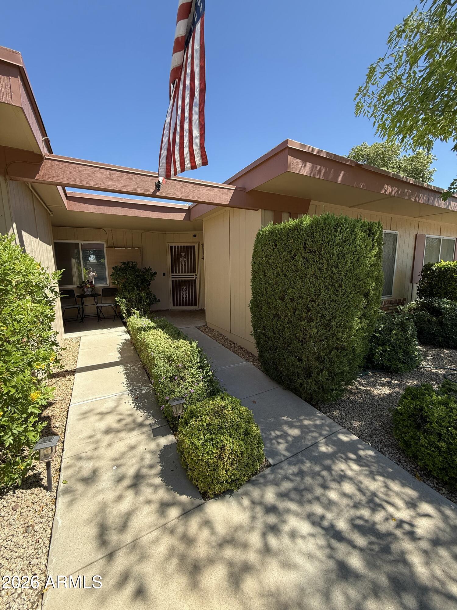 Fantastic end-unit townhouse nestled in a desirable 55+ community in Sun City ready for some TLC to make it yours! Discover inviting living spaces filled with natural light for endless entertainment. The  kitchen provides plenty of cabinetry and ample counter space. Generously sized bedrooms offer comfort and flexibility, complemented by full bathrooms designed for convenience. Your private backyard retreat has a covered patio + extended paver seating area perfect for relaxing mornings or sunsets. Do not miss the 2-car rear-entry garage with a dedicated laundry area! Enjoy the community pool, heated spa, golf, gym, and more. Ideally located within walking distance to Banner Boswell Hospital, as well as nearby restaurants and shopping. This is the active adult lifestyle you've longed for!