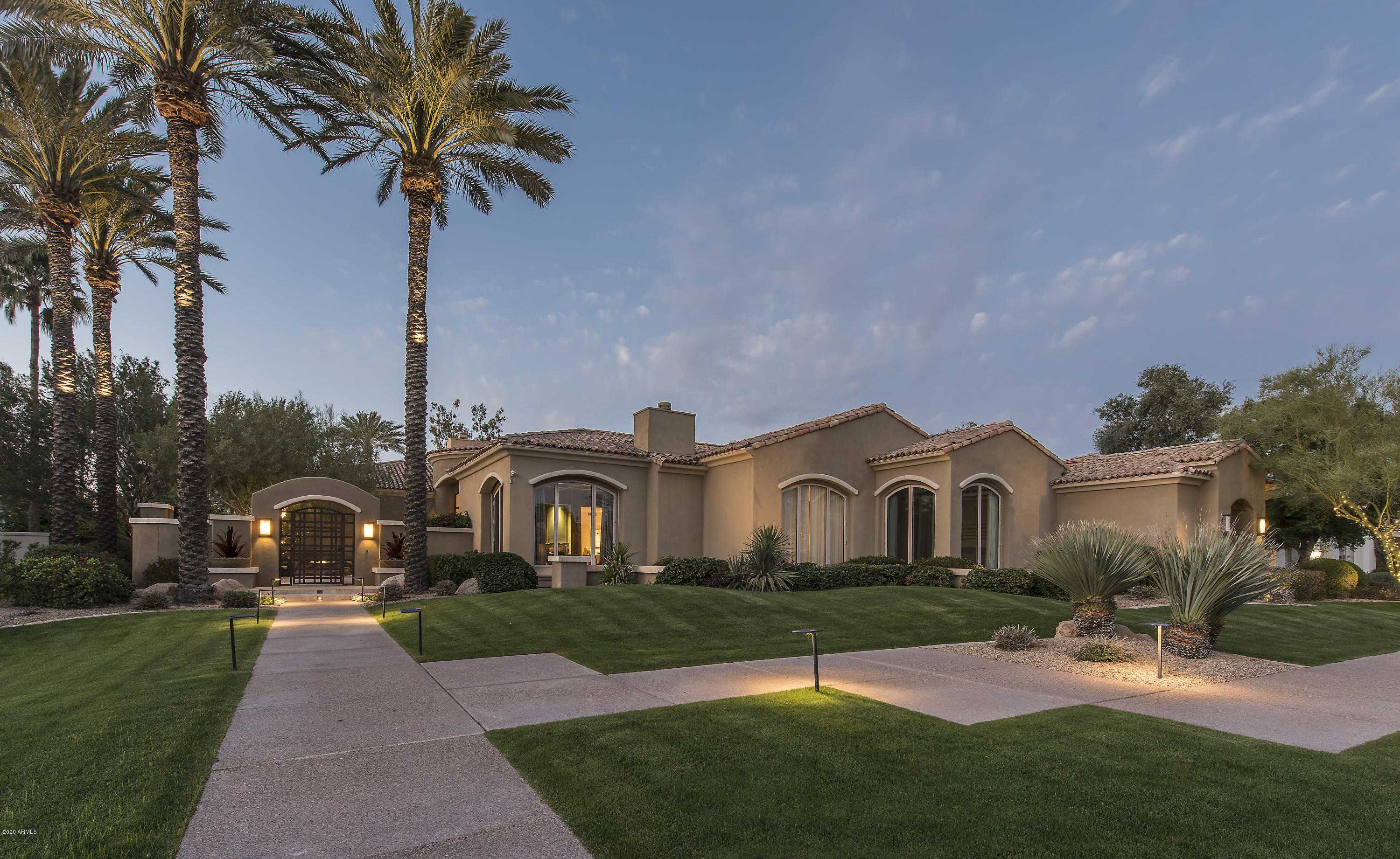 Incredible custom home in gated community of Cheney Estates. Sits on .75 acres and backing to the golf course with N/S exposure. One of the largest lots in all of Cheney Estates. Home is perfect for lock and leave executives, as you have 4 bedrooms, (all en-suite) with office, in the main house, and detached guest house/ man cave, with two offices and game room for entertaining and business meetings. *GUEST HOUSE CAN EASILY BE USED AS 2 ADDITIONAL BEDROOMS. Every detail of this home was well thought. Mature landscaping throughout the grounds, with putting green, covered ramada, heated lap pool & spa. Privately gated entrance, and soothing water features and fireplaces in/out of the home. Professional lighting consultants used to capture the perfect lighting in day & night. This home glows! Evening showings will impress your clients!