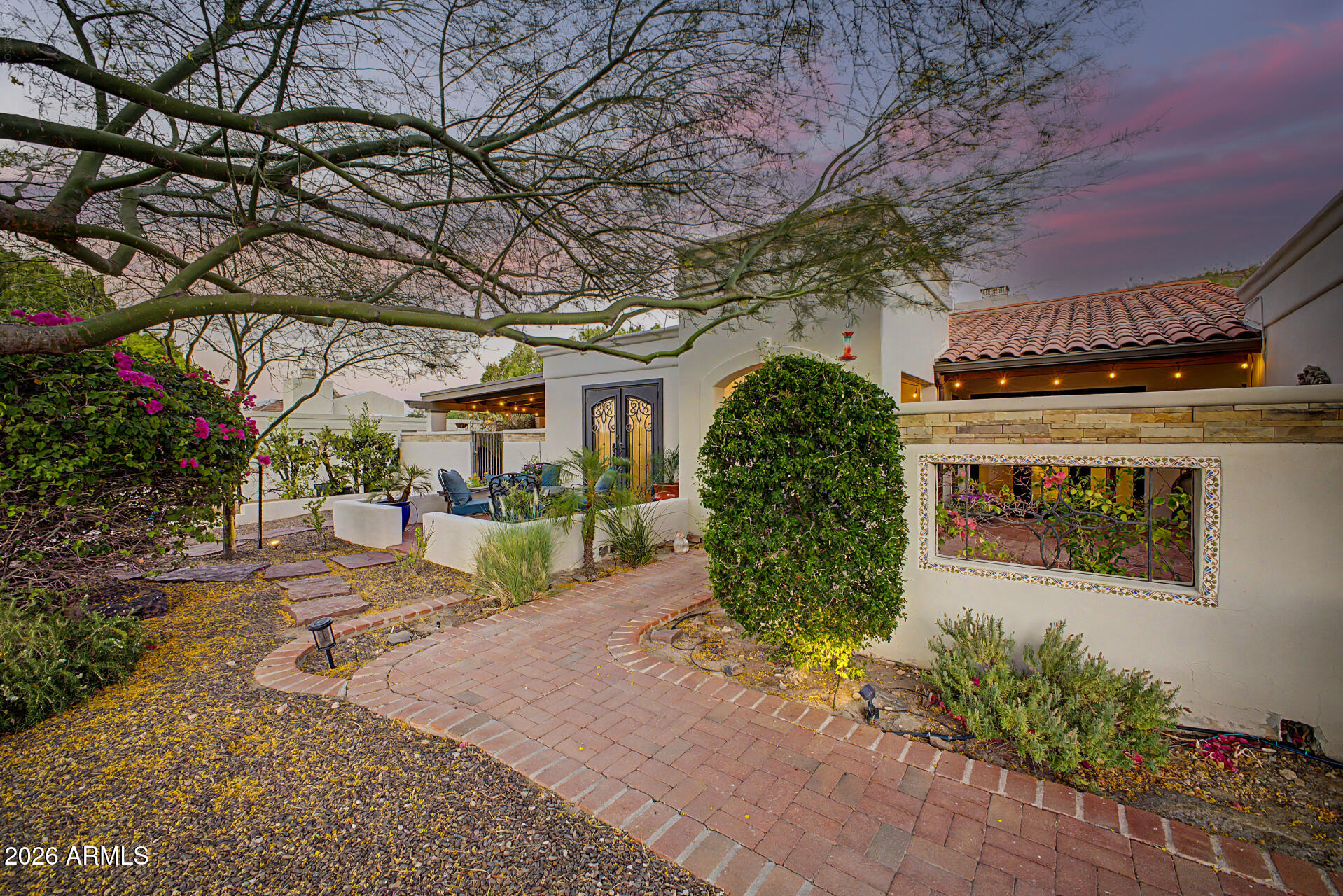 Stunning Spanish Colonial at the foot of Shaw Butte. 3 bedrooms, 2 bathrooms 2,435 square feet. Enter into the stylish iron and glass entry door to a living area featuring exposed wood beams, stunning stonework and distressed brick accents. The gourmet kitchen features a large center island with seating, abundant workspace, and premium Monogram appliances. The luxurious primary retreat exudes refined comfort, complete with a cozy sitting area with a fireplace and French doors that open directly to the private rear patio. Situated on a view lot within the highly sought-after Moon Valley area, the grounds feature multiple patios for entertaining, mature landscaping, and a beautiful heated saltwater pool. This immaculate residence is ideally located near desirable schools, Moon Valley Country Club, Gold Key Racquet Club, shopping, freeways and more. You are steps from hiking and biking trails in Phoenix Mountain Preserve.
