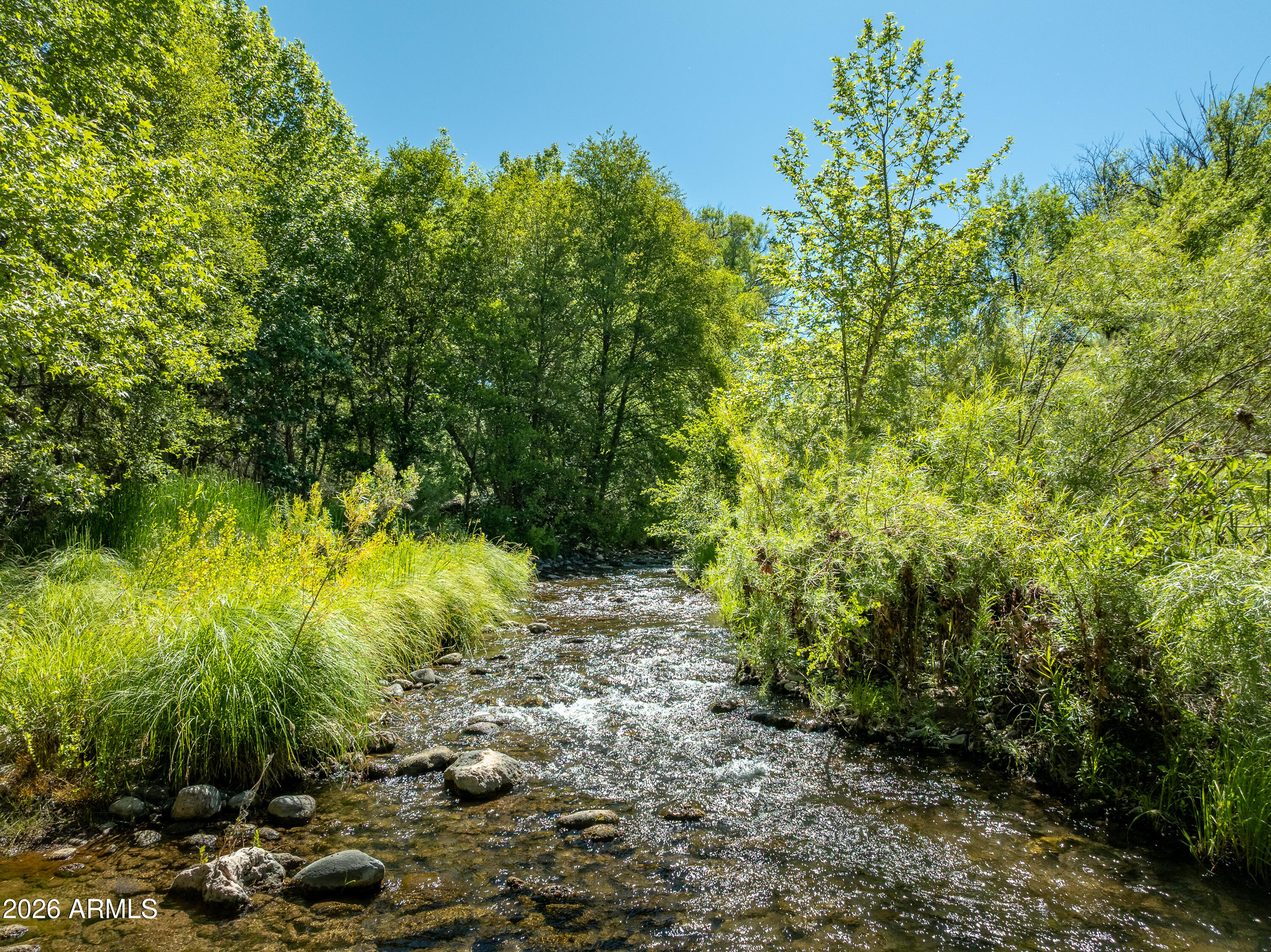 Experience the freedom & beauty of Northern Arizona with this rare 2.5-acre creek-front lot featuring over 200ft of Beaver Creek frontage, lush mature trees & breathtaking natural surroundings. A truly unique opportunity, offering the perfect blend of flowing water, privacy, open space & stunning views, creating an unforgettable setting for your future dream home, retreat, or investment. Enjoy the peaceful sounds of the creek, shaded riverbanks & nature right in your own backyard. With easy access, nearby utilities, & plenty of usable land above the creek area, this property offers both functionality & incredible scenery. A short drive from Sedona, Cottonwood, & outdoor fun, this is a rare chance to own one of Rimrock's most picturesque creek-front properties.