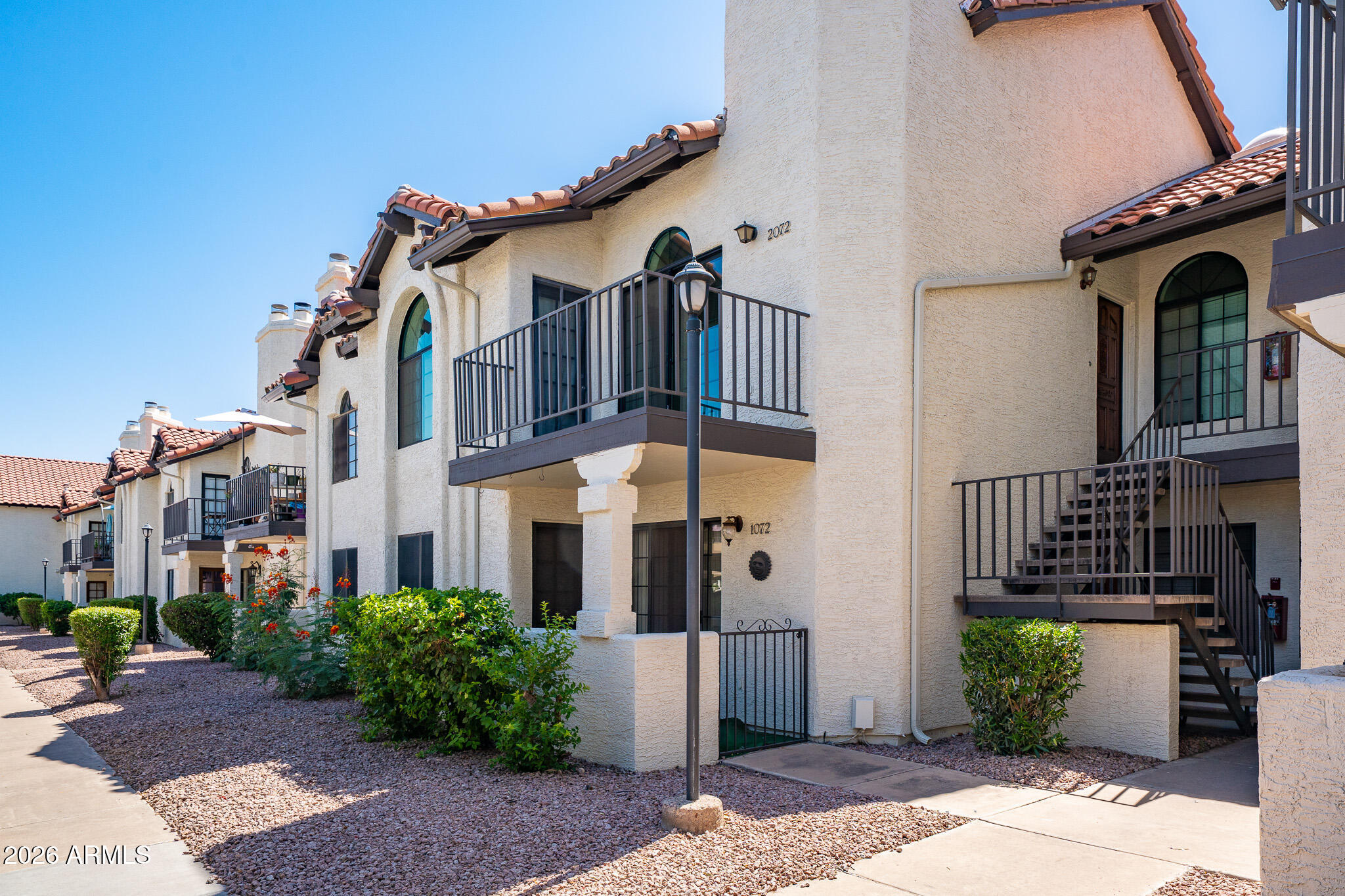 Live the Scottsdale lifestyle in this beautifully updated, light-filled condo with soaring vaulted ceilings and a bright, open feel. Enjoy energy-efficient living with 2021 HVAC and dual-pane windows/patio doors for lower bills and added peace and quiet. Stylish 2018 remodel features updated flooring, modern kitchen, and refreshed baths with quartz countertops and tile backsplash. Unwind in the spacious primary suite with walk-in closet, dressing area, and oversized walk-in shower. Split guest bedroom offers privacy, walk-in closet, and its own balcony access. Cozy up by the fireplace or relax on your private balcony. Includes covered parking. Resort-style amenities: heated pool/spa, tennis, racquetball, and fitness center. Unbeatable location near  Loop 101 & Shea