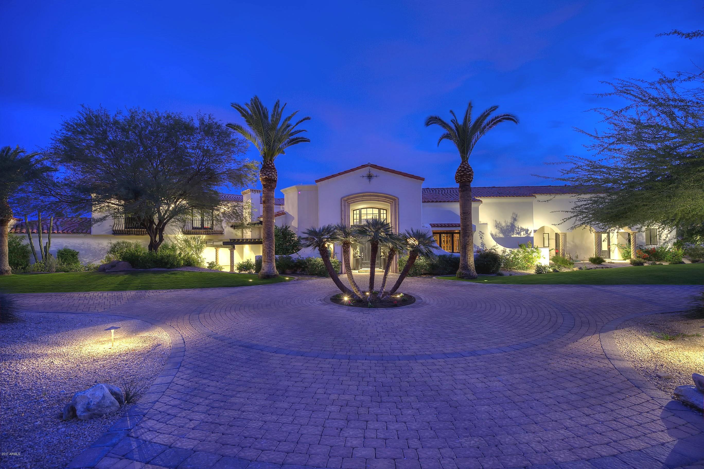 YOUR PRIVATE 3+ ACRE ESTATE, Remodeled by Jack Black, this estate has dramatic 30' living room ceilings & views of the mountains through a 20' window! Exuding Hollywood Regency style with Carrara marble and black granite flooring, fully paneled library, a chef's kitchen opening to a family room, a master suite w/ an exercise room and sitting room with a two-way fireplace. The master suite hosts his/her closets with glass cabinet doors. The 3 additional bedrooms are connected by a large computer/playroom. Property offers a tennis court, pavilion, pool and spa with cabana. Car enthusiasts will love the 9 car garage! All this complete with 1,546SF guest home with two bedrooms, two baths, a kitchen, living room with a fireplace, dining, laundry and it's own garage.