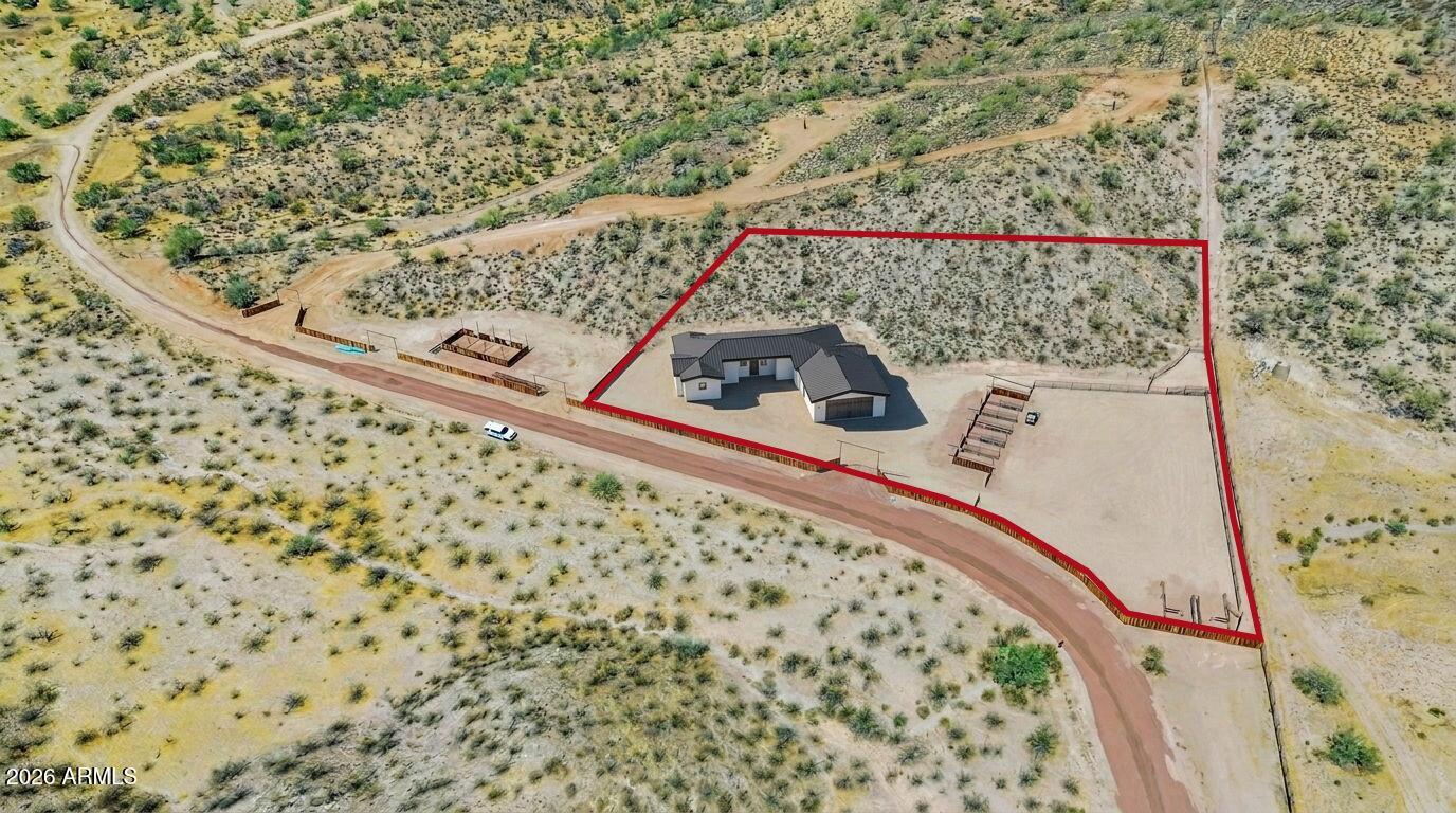 Immaculate new-construction horse property in Wickenburg, AZ, estimated completion October 15, 2026. This 3,000 sq ft home plus 500 sq ft covered patio features an open-concept split floor plan with modern design, and there's still time to customize finishes and add your personal touches. Ideal for ropers and horse enthusiasts, the property includes a 6-stall barn with wash rack and automatic waters, a roping arena, and horse-friendly layout. Enjoy a private well, automatic gated entry, and a prime location: just 5 minutes to Rancho Rio roping arena and 7 minutes to historic downtown Wickenburg. This property will be turn-key and ready for you to put your horses away and enjoy the Arizona sun. Artificial photo renditions of home, currently under construction.