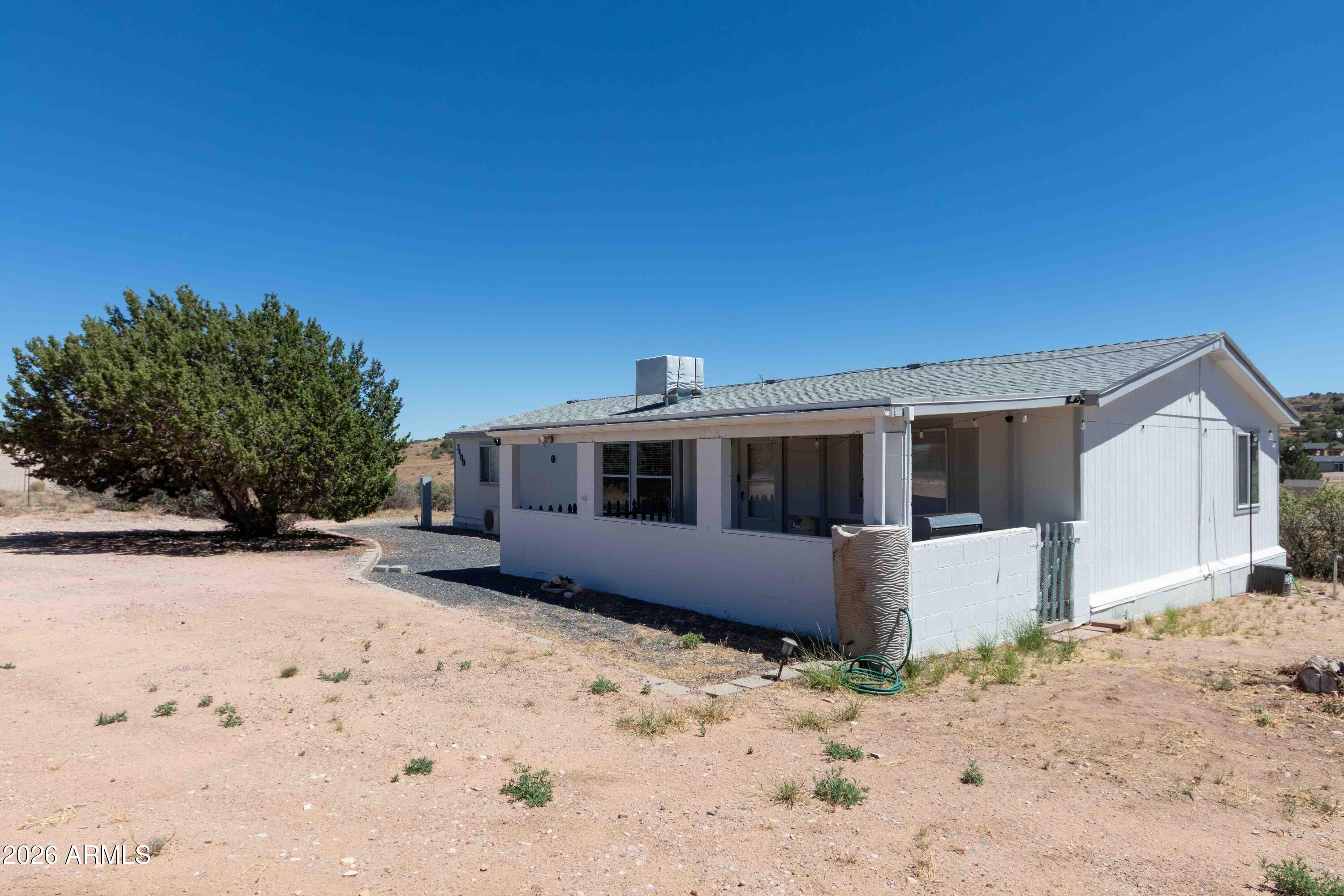 Welcome to your dream high-desert retreat in beautiful Chino Valley! Situated on a premium 1.08-acre lot, this beautifully updated 3-bedroom, 2-bathroom Cavco home offers 1,569 square feet of modern, move-in-ready comfort. Every detail has been meticulously refreshed, boasting a brand-new roof, fresh interior and exterior paint, and stunning new flooring throughout. The heart of the home features an upgraded kitchen perfect for home chefs, alongside beautifully modernized bathrooms. Step outside to your expansive acreage and take in the panoramic, breathtaking mountain views that truly define Arizona living. With plenty of space for your horses, toys, or a future workshop, this rare gem seamlessly blends open country freedom with stylish, contemporary living.