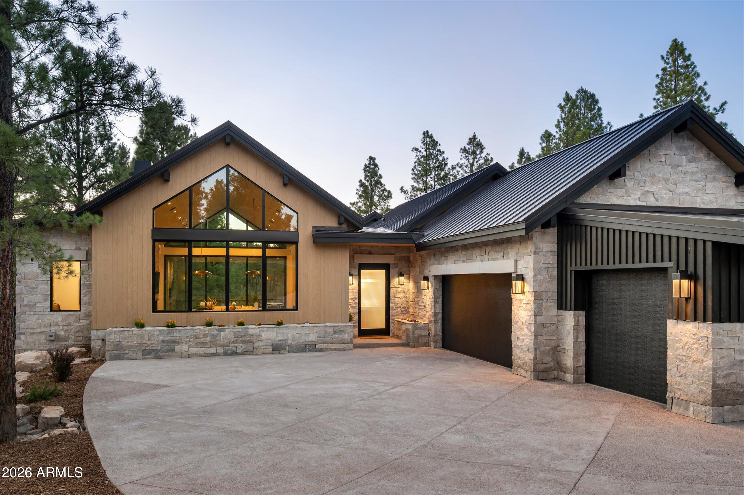COMPLETED AND MOVE-IN READY JUNE 20, 2026! Nestled at the end of a private cul-de-sac in Pine Canyon, this exceptional custom residence by Two Hawks Design & Development, with architecture by The Ranch Mine, offers approximately 5,400 square feet of thoughtfully designed living space overlooking the 2nd hole of the golf course with stunning mountain views beyond. The main level features the primary suite, a second primary suite, dedicated office, powder room, and an expansive great room designed for seamless indoor-outdoor living. The basement level includes a spacious secondary living area, 3 additional en-suite bedrooms, a second powder room, and a convenient laundry station. With generous outdoor living spaces, a 3-car garage, and a premier location just minutes from the club house. and seamless indoor-outdoor flow. Inside, the craftsmanship with spacious living areas, curated finishes, and walls of glass that frame the surrounding landscape. The three-car garage provides ample storage for vehicles and mountain gear alike. Located just moments from the Pine Canyon clubhouse and community amenities, this home presents a rare opportunity to enjoy premier golf course living in one of Flagstaff's most sought-after gated communities.