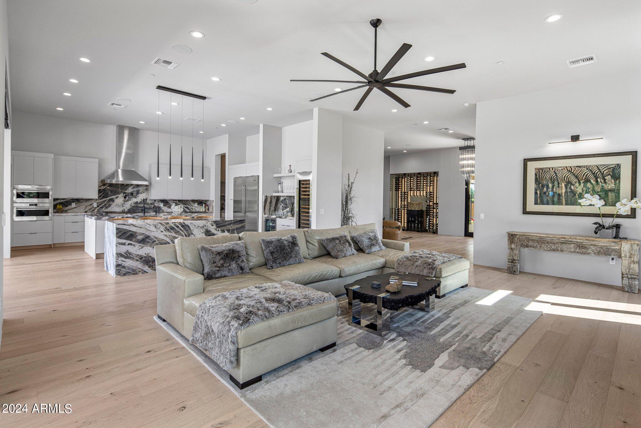 Welcome to your luxurious contemporary oasis nestled in the heart of Scottsdale. This single-story masterpiece boasts sophistication and modern elegance at every turn. As you step through the grand entrance, you are greeted by a spacious and airy open floor plan that seamlessly blends the living, dining, and kitchen areas. Soaring ceilings and expansive windows flood the space with natural light, creating an inviting atmosphere for both relaxation and entertainment. The gourmet kitchen is a chef's dream, featuring sleek quartzite countertops, state-of-the-art appliances, and ample storage space.  Retreat to one of four luxurious bedrooms each with its own ensuite bathroom for ultimate privacy and comfort.The master suite is a sanctuary of relaxation, complete with a spa-like ensuite bathroom and direct access to the outdoor living area.
Step outside to your own private paradise, where you'll find a heated pool and spa, perfect for year-round enjoyment. Spend lazy afternoons lounging by the pool or soaking in the soothing waters of the spa. Practice your putting skills on the immaculate putting green, or simply unwind in the lush turf backyard surrounded by manicured landscaping.
Entertain guests al fresco in the outdoor living area, complete with a built-in barbecue grill and cozy seating area. With its sleek design, luxurious amenities, unparalleled attention to detail, and 3 car garage this contemporary home offers the epitome of modern living. Welcome home to a lifestyle of luxury and sophistication.