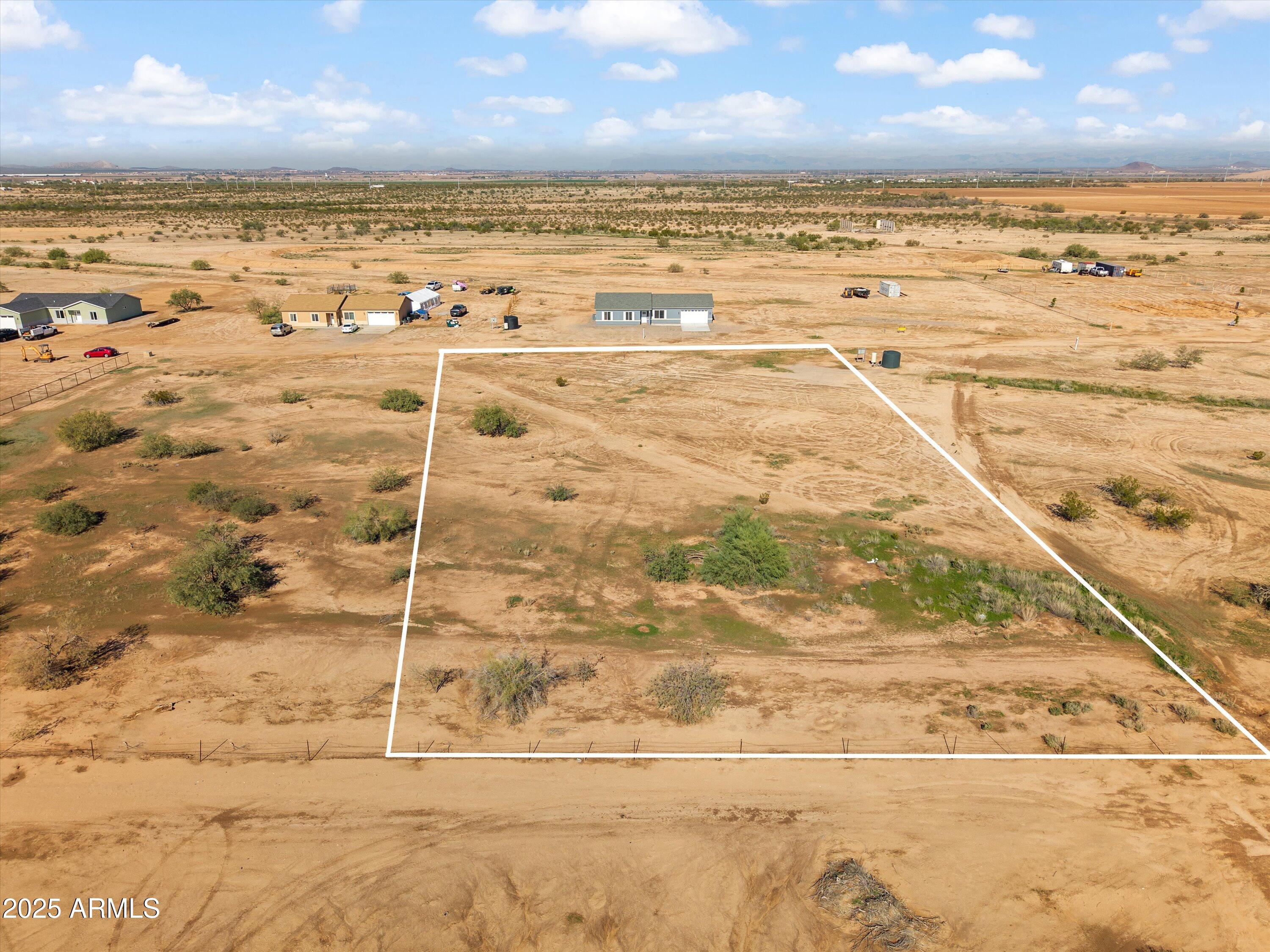Discover the perfect blend of quiet rural living and convenient access to amenities on this beautiful 1.25-acre lot in Coolidge. 

This flat 165' x 329' parcel offers expansive panoramic views and is build-ready. Essential utilities are already in place including an APS transformer and a well water meter box, saving you the significant cost of bringing in power and water. A shared well agreement is included for your convenience. One adjacent lot is also available, offering the option to expand and create an even larger private estate. Build your dream home in this peaceful and scenic corner of Pinal County just 5 miles from Coolidge and 6 miles from Downtown Florence. 

This listing is the east lot (MLS: 6952919  /parcel #: 20225020) and is solely the land. The neighboring lot to the west (MLS: 6953020/ Parcel #: 20225019 ) is also for sale. Both properties also have blueprints available to build semi custom homes.