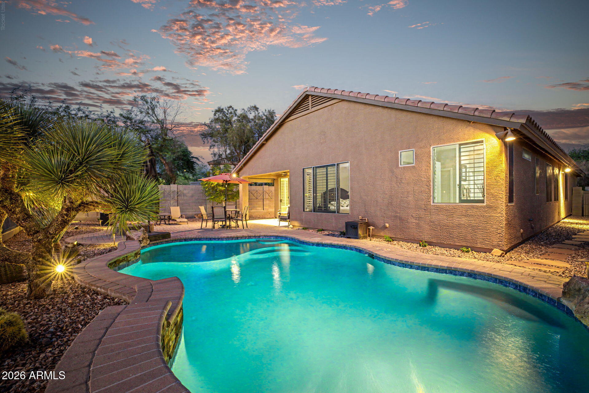 Incredible opportunity in Anthem Parkside! This stunning single-story home backs to the breathtaking Sonoran Desert, offering panoramic mountain views and a resort-like backyard. The outdoor oasis features a sparkling heated pool, elegant stacked stone accents with a waterfall, a spacious extended paver patio and gas fire pit, and a built-in barbecue. Benefit from exceptional savings with a fully paid-off owned solar system. 

Inside, this residence showcases a lovely front formal area adorned with brand-new carpet and wooden shutters, perfect for entertaining family and friends. The formal living room and dining room provide versatile spaces that can easily accommodate a pool table or any other personal touches. The spacious kitchen is a chef's dream, featuring a perfectly sized island with a breakfast bar, luxurious granite countertops, honey oak cabinets, and a stylish stacked stone backsplash. The deep graphite composite sink and stainless steel appliances enhance functionality, while large windows flood the area with natural light, creating a seamless flow into the expansive living room that overlooks the pool and the stunning desert landscape.

Retreat to the exquisite primary suite, which boasts brand-new carpet and generous space, leading to a spa-like bathroom complete with travertine floors, remodeled walk-in shower, a large jetted tub, rubbed bronze fixtures, double sinks, and ample cabinetry. Two walk-in closets provide abundant storage.

Step outside to discover the large, sparkling pool featuring a Baja step overlooking Daisy Mountain. The  backyard features an enormous extended paver patio and is equipped with ceiling fan, built-in speakers, and a gas fire pit, making it ideal for entertaining. The backyard is a serene escape, surrounded by stunning Cacti, mature trees and the captivating desert scenery and wildlife. 

Garage is completely finished with epoxy, storage cabinets, new soft water system in 2021 and newer hot water recirculation pump. How wired for Cat 5 Internet and has an active alarm/security system. Laundry room is extended with additional sink.

Benefit from the low Anthem Parkside HOA dues while indulging in outstanding amenities, including a picturesque 16-acre park with a catch-and-release lake, a sprawling playground, extensive walking paths, and a community center equipped with a state-of-the-art fitness facility, indoor basketball courts, a large lap pool, exhilarating water slides, tennis courts, pickleball, bocce ball, and one of Arizona's largest skate parks.

This is the home you've been waiting for!