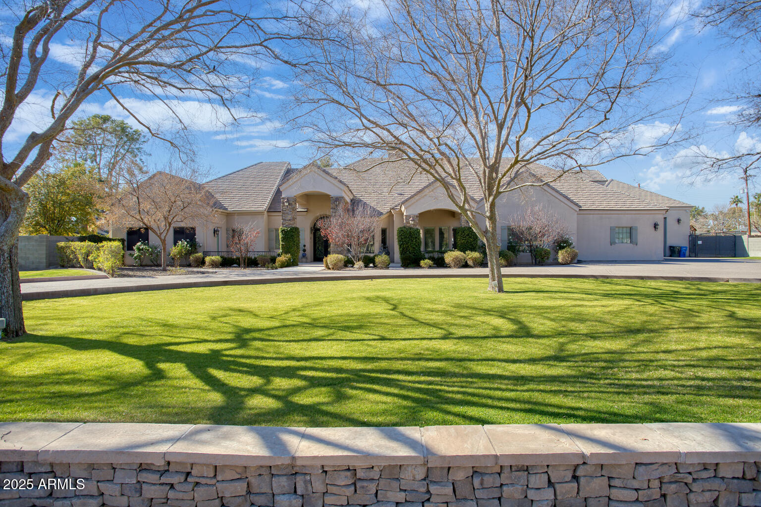Welcome to this very special Royal Palm/North Central Phoenix estate, where thoughtful design meets comfort and practicality. Tailored for relaxation, entertaining, and accommodating a myriad of lifestyles. From the circle drive arrival, through the inviting front porches - inside, gaze through the beamed grand room's retractable glass wall, across the saltwater pool, to the firelit, elevated ramada and surrounding lush grounds. The professional island kitchen, butler's pantries, and great room host dual dishwashers and refrigerators; Wolf and Sub-Zero appliances - including a steam oven. The home has five generous bedrooms plus the completely private - fully equipped - one-bedroom apartment. The primary suite provides fireplaces in both the bedroom & spa bath; steam shower, private outdoor spa and shower. There's also a designated office/bonus room. This acre-plus lot includes a barn/tack and storage building along with two over-sized garages. Whether you enjoy hosting groups of any size - inside or out; solitary morning walks, easy Sky Harbor Airport commutes and downtown Phoenix culture and athletics; you'll appreciate the convenience of the Royal Palm community. Welcome home.