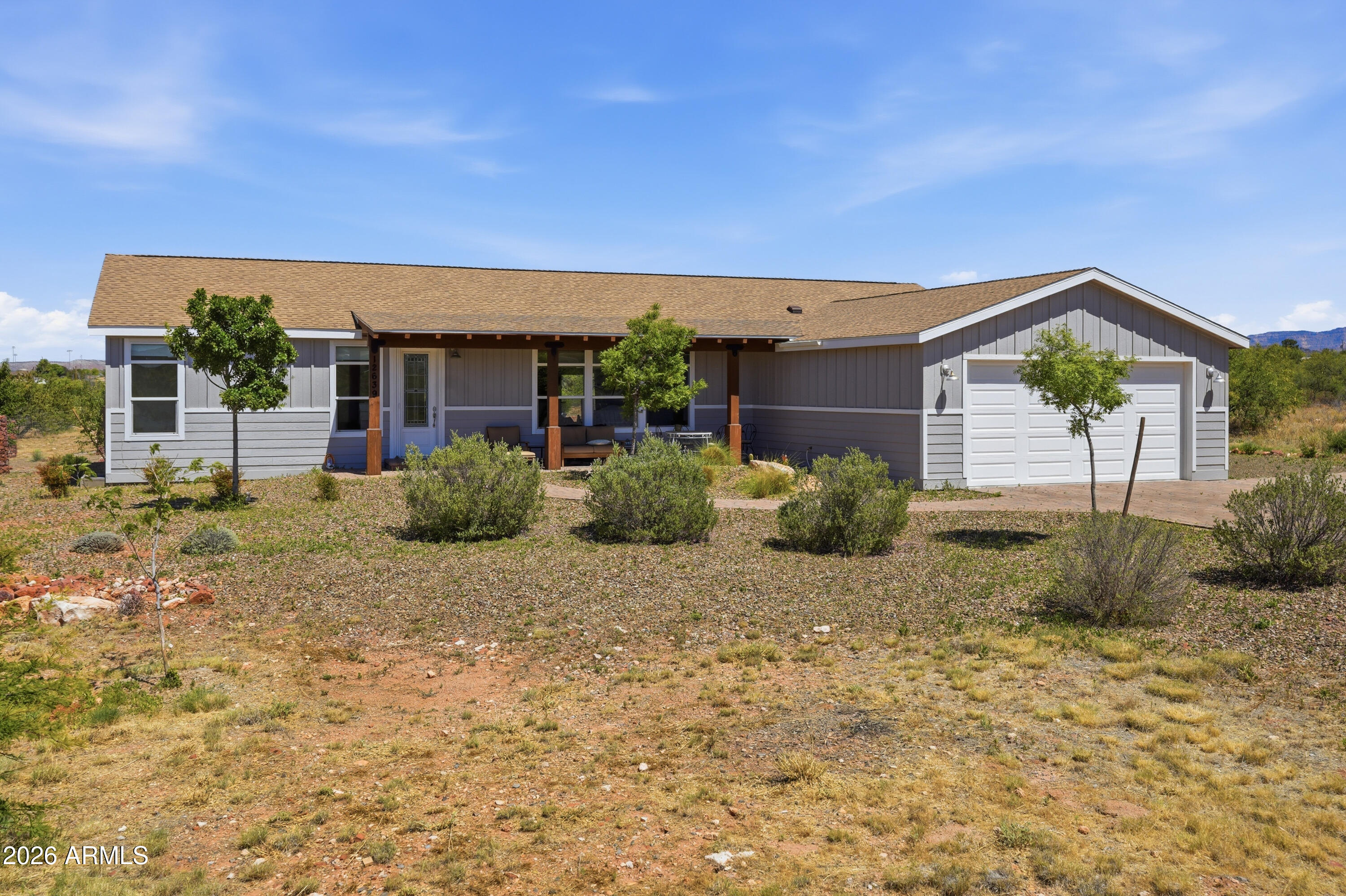 Welcome to Mingus Panorama Estates, where breathtaking mountain views, peaceful country living, and room to spread out come together on nearly an acre of land. This beautifully maintained 3-bedroom, 2-bath home offers approximately 2,170 square feet with a desirable split floor plan designed for both comfort and privacy.

The spacious great room serves as the heart of the home, providing an inviting space for gathering with family and friends while taking in the surrounding views. The generously sized primary suite features an ensuite bath complete with a relaxing soaking tub, separate walk-in shower, and an oversized walk-in closet.

Step outside to enjoy the fully fenced backyard, where fruit trees including apricot, apple, plum, and peach create your own private orchard. The .91-acr The .91-acre parcel offers plenty of room for gardening, entertaining, pets, or simply enjoying the tranquility of the Verde Valley and Page Springs Wineries. Take in stunning mountain vistas by day and the twinkling lights of Jerome by night.

Additional highlights include a Pentair Water Descaler Treatment System, a private community water system supplied by the subdivision's well, a 2-car garage, and a new roof installed in 2024 for added peace of mind.

Experience the perfect blend of comfort, functionality, and scenic beauty in this exceptional Cornville property.