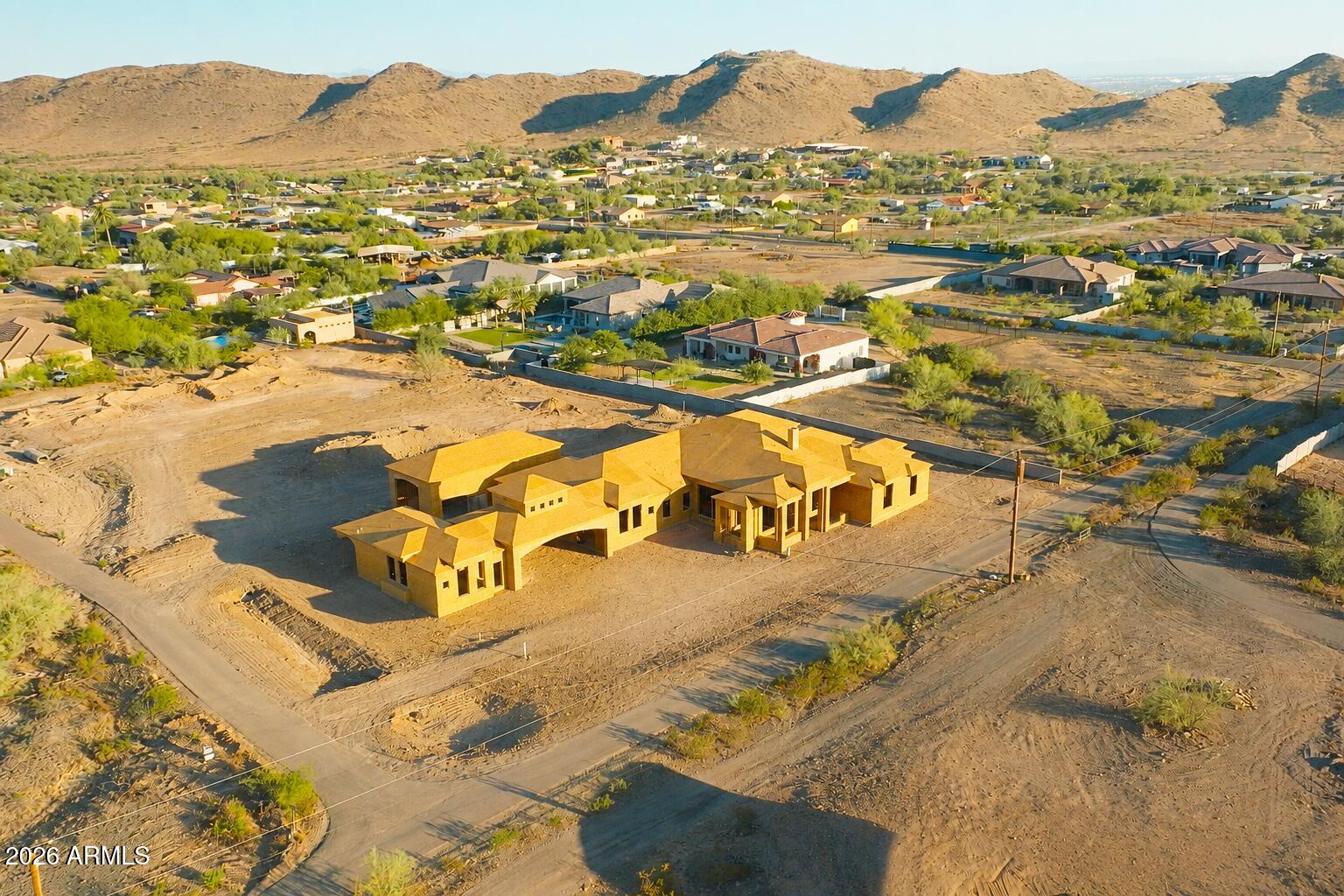 Offered by Arizona Building Group LLC, a builder whose estate-level pedigree is evident in every structural and architectural decision, 3902 W Kayenta Trail represents a rare convergence of craftsmanship, land, and location within the exclusive, low-density enclave of Sunset Cove Estates. 

Set on a full-acre homesite with sweeping views of South Mountain and Carver Mountain, and positioned just steps from the trailheads of South Mountain Park, this never-lived-in new construction estate totals approximately 5,486 sq ft and is composed with the intentionality of a builder who creates estates, not houses. 

The grand porte-cochere arrival sets the tone from the moment you pull off the road. The main residence (~4,814 sq ft) delivers four bedroom suites, each with a private en-suite bath anchored by a soaring vaulted family room, a chef's kitchen with pantry and breakfast nook, a dedicated game room, a private office, and a primary suite of genuine retreat scale. Over 1,300 sq ft of covered patio extends the living space into the Arizona landscape with the kind of intentionality this builder is known for. 

The detached casita (672 sq ft) includes its own kitchen, living area, and private garage, a self-contained space ideal for guests, extended family, or the ultimate in-law suite. A separate 55x24 RV garage completes a compound designed for the full scope of estate living. Total garage capacity: six vehicles. 

The outdoor living space is a resort unto itself. A large pool anchors the backyard alongside an attached spa, both set within an expansive paver deck designed for Arizona living at its finest. A modern pergola frames an outdoor lounge and fire pit area, the kind of space where the line between inside and outside simply stops mattering. The mountain backdrop visible from every corner of the yard is not borrowed scenery; it is a permanent feature of this address.

Built with 2x6 structural framing, engineered concrete slabs, and open-cell spray foam insulation throughout, this is the construction standard of a builder for whom structural integrity is non-negotiable. 

Sunset Cove Estates enforces estate-level land standards (minimum 1-acre homesites, 3,000+ sq ft single-level homes), ensuring that the privacy, separation, and permanence of this setting are protected by design. The sunrises and sunsets here are not a selling point; they are a daily reality for the people who find their way to this address. 

For buyers who know: this is the one.