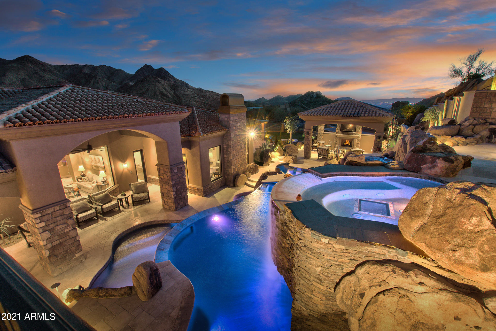 Magnificent Elevated Sonoran Desert Retreat with one-of-a-kind 3-tiered swimming pool/spa.  Elevated spa with city and mountain views and Plexiglass floor to view grotto below.  11-foot-deep diving pool, additional pool, multiple water features, custom lighting and swim up bar!  Simply AMAZING!  Luxurious custom home with honed limestone floors, knotty alder cabinets, custom closets, custom ceiling details in every room, all custom toilets, 6'' stone baseboards, extensive custom faux designer touches, a 48'' gas wolf oven with griddle pot filler double oven, a butler's pantry located within the chef's gourmet kitchen, a Miele espresso room, 2nd master, open family room, kitchen, game room, and oversized 4 car garage.  Multiple patios, ramadas, fireplaces, and view deck for stargazing and city light and mountain views.  Open floorplan with 20 foot automatic all glass pocket door that opens from the great room, game room and wet bar to the patio and pool area. Absolute sophistication!  A must see!