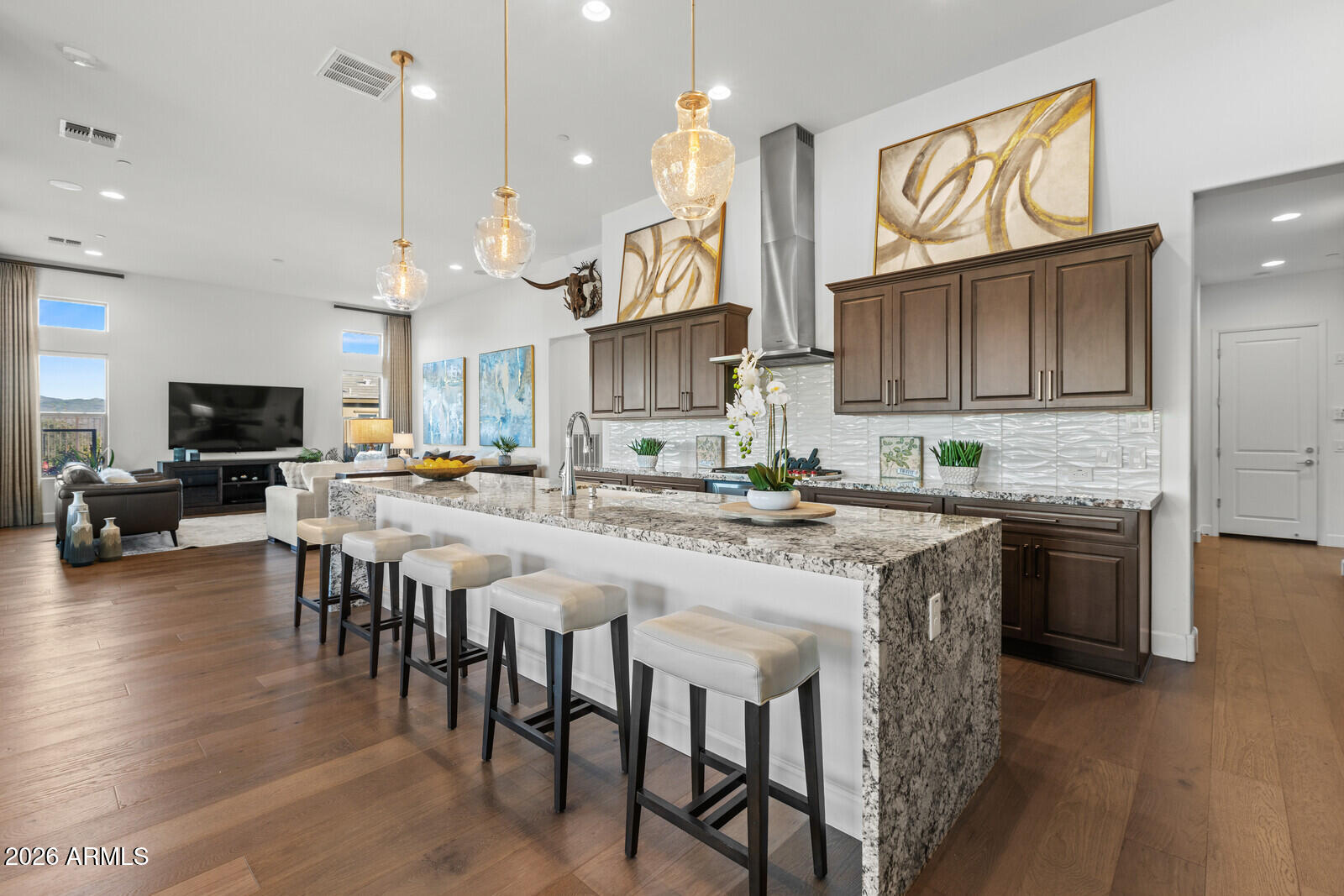 Wonderful mountain views highlight this premium wedge-shaped homesite featuring the highly sought-after Dorado floor plan — a rare three-bedroom, three-and-one-half-bath design with all en-suite bedrooms, plus a private den.

This exceptional residence showcases numerous luxury upgrades, including a gourmet kitchen appointed with Wolf and Thermador appliances, an expansive granite island, walk-in pantry, and a dedicated butler's preparation bar. Additional features include an extended three-car garage, extended covered patio, rich wood flooring, central vacuum system, and built-in wine storage beneath soaring 12-foot ceilings.

The thoughtfully designed owner's suite offers dual walk-in closets and breathtaking mountain views. Complemented by wireless automated blinds in the owner's suite, living room, and dining room. A separate den/office and Smart Space provide added flexibility and functionality.

Designed for refined indoor-outdoor living, the backyard is an entertainer's dream  showcasing panoramic mountain vistas, a resort-style pool and spa, built-in grilling station, gas firepit, and five distinct seating areas for optimal gathering and relaxation.

Modern conveniences include a Tesla charging station and Smart App integration for the pool and spa, thermostat, appliances, and lighting controls.

Located within the lush Sonoran Desert of Arizona, Verde River Golf & Social Club  the centerpiece of the Trilogy® at Verde River community  borders the Tonto National Forest and offers sweeping views of the Mazatzal Mountains and the iconic Four Peaks.

Residents enjoy access to a Tom Lehman-designed championship golf course, tennis and pickleball courts, a poolside bar and grill, and a luxurious resort-style pool with panoramic views extending to Weaver's Needle. The Outfitter serves as the gateway to outdoor adventure.

The exceptional 30,000+ square-foot clubhouse features thoughtfully designed indoor and covered patio spaces where members and guests enjoy a wide range of amenities, including fine and casual dining venues such as Needle Rock Kitchen & Tap and Eddy's Poolside Diner, the proprietary Afturburn fitness concept, Alvea Spa, an events center, Test Kitchen, Artist Loft, and much more.

Be Sure to Watch the Video in Photos Tab