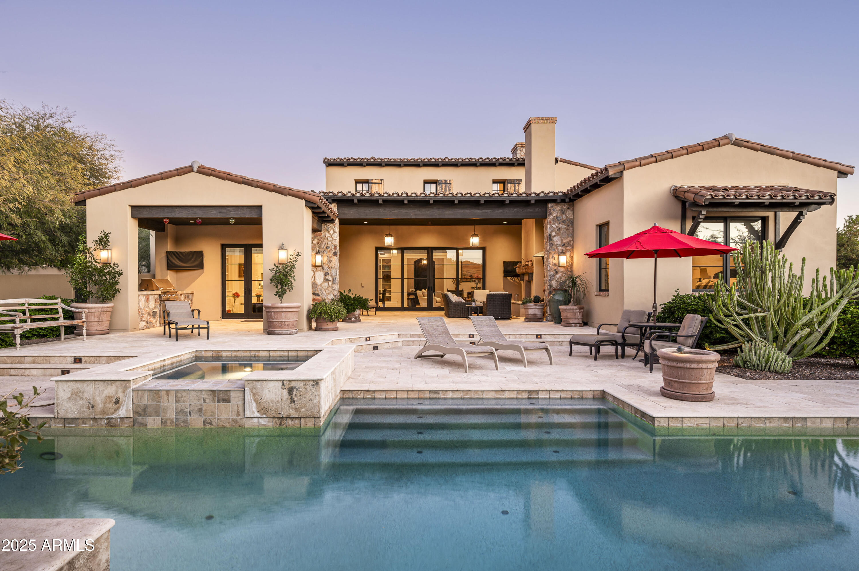 Located in the prestigious Windgate Pass neighborhood of Silverleaf, this stunning 5,154-square-foot custom home is a true testament to modern luxury and thoughtful design. Designed and built by the renowned Calvis Wyant Luxury Homes, this residence blends sleek contemporary style with impeccable high-end finishes, creating a home that is as functional as it is beautiful.
With 5 bedrooms, including a separate guest casita, 6 bathrooms, a den/office, and a versatile bonus/media room, this home offers the perfect balance of space, comfort, and sophistication. The main living areas are thoughtfully designed with large pocket doors that seamlessly connect the interior to the beautifully landscaped backyard, creating the ultimate indoor/outdoor living experience. Sitting on an 18,991-square-foot lot, the outdoor spaces are a true Arizona oasis. The oversized sparkling pool is the centerpiece of the backyard, offering a serene retreat for relaxation or a stunning backdrop for entertaining. The expansive patio areas and lush landscaping are ideal for hosting gatherings or enjoying the tranquility of the surrounding desert.
Inside, every detail of this home has been meticulously crafted to exude both elegance and warmth. The sleek, modern aesthetic is complemented by an open floor plan, ensuring a natural flow throughout the home. The gourmet kitchen, with its top-of-the-line appliances and exquisite finishes, is perfect for culinary enthusiasts, while the spacious living areas provide a welcoming atmosphere for family and friends.
This exceptional home, located in one of Scottsdale's most sought-after communities, offers access to world-class amenities, breathtaking views, and the unparalleled lifestyle that Silverleaf is known for. Whether you're looking for a private sanctuary or a perfect home for entertaining, this residence offers it all.