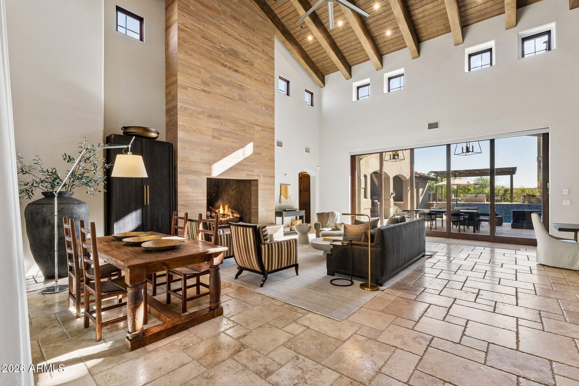 Nestled on the quiet, tree-lined streets of Arcadia within Silverleaf at DC Ranch, this Spanish Contemporary residence offers a refined expression of desert luxury. A gracious foyer opens to a dramatic great room with timber-vaulted ceilings, a soaring fireplace, and retractable glass doors that connect seamlessly to the courtyard. Designed for elevated everyday living and effortless entertaining, the chef's kitchen features a generous island, bocci chandelier, walk-in pantry, and wine room. Upstairs, dual primary suites and two additional bedrooms provide comfort and flexibility, while a private guest suite includes its own fireplace, laundry hookup, and separate entrance.
A rare offering in one of Scottsdale's most coveted communities, blending timeless design, and exceptional amenities
