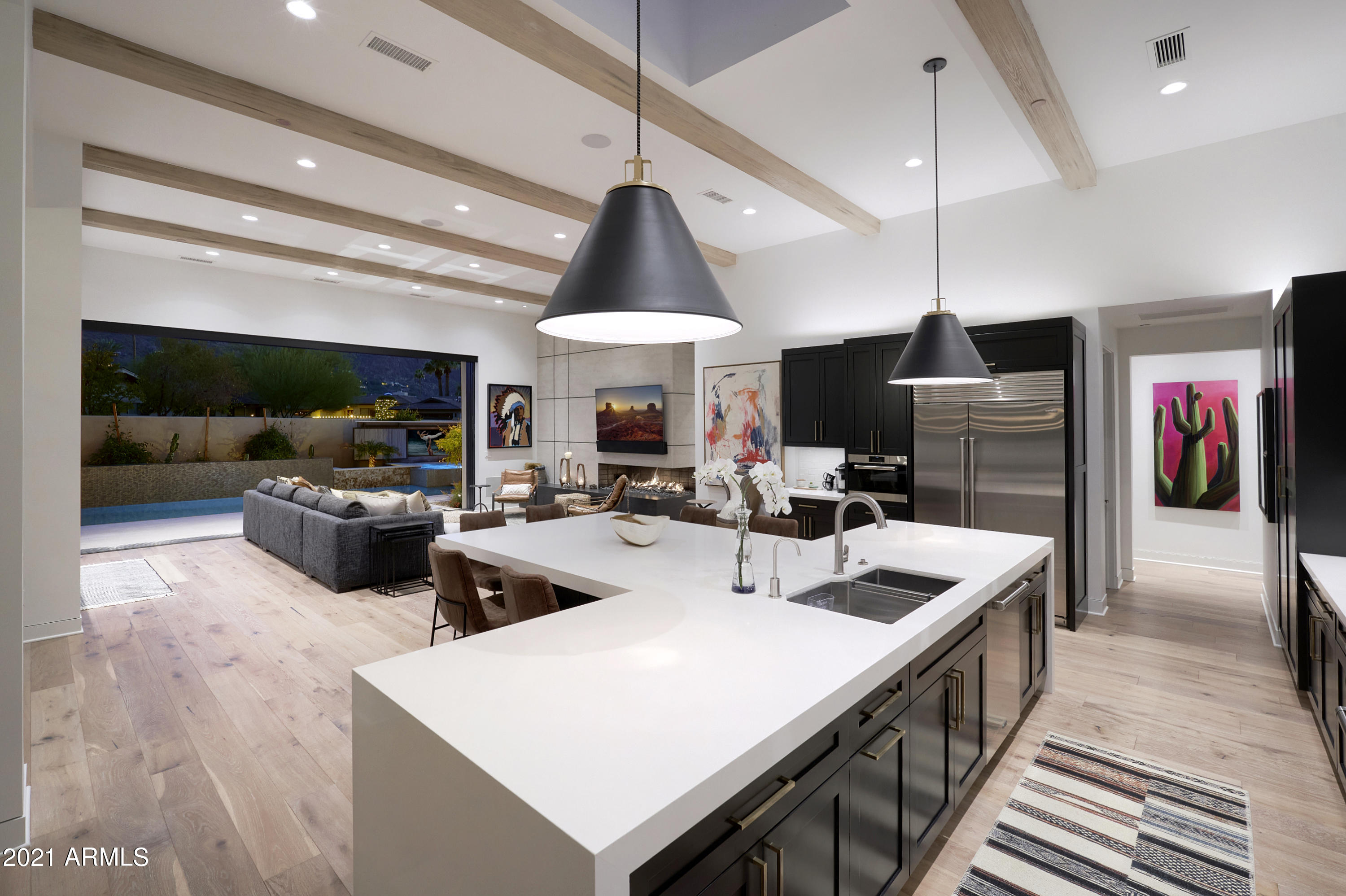 THIS IS THE ONE YOU HAVE BEEN LOOKING FOR. Single level, new construction, Head to Tail PANORAMIC VIEWS OF CAMELBACK MOUNTAIN, open concept indoor/outdoor living, low maintenance, and nestled in a guard gated community in the heart of Paradise Valley. This stunning custom home built by renowned Cullum Homes takes luxury Paradise Valley living to a different level, with no expense spared on the highest end finishes and upgrades. The only residence in the Village at Mountain Shadows with YOUR OWN PRIVATE POOL, HOT TUB WITH OUTDOOR TV as well as a BBQ AREA WITH BAR AND TV, imagined and brought to life by award winning Creative Environments, perfectly framing and capturing the ''in your face'' Camelback Mountain VIEWS. From the moment you enter the home SEE MOTION VIDEO your eyes are immediately drawn to the grand main living space which defines luxury indoor/outdoor living. The Chef's Kitchen boasts a large center island, designed perfectly for entertaining guests, and features the highest end Wolf/SubZero appliance packages. The kitchen flows seamlessly to your main living space which features a wet bar with fridge and wine fridge, custom fireplace and a custom automatic sliding wall of glass that pockets to bring the outside, in. The thought and detail behind this property was to create an Entertainer's Paradise with resort living 365 days a year, as well as maintaining the integrity of a "Homey" feel. The Master Retreat is stunning and has separate access to the resort backyard, as well as a large walk-in shower with oversized tub and a spacious closet. The secondary bedrooms are spacious and feature their own custom designed en-suite bathrooms. The property features the highest end A/V systems, indoor/outdoor surround sound, as well as added security features aside from being in a guard gated community. The garage is both air conditioned and heated as well. The seller's paid a premium to have arguably the best view lot in the community and their design features are the highest end and quality. Nearly $320,000 worth of upgrades were added. Call to set up your private showing today.