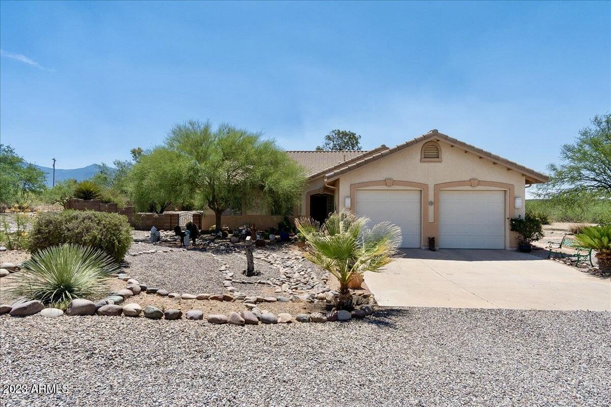 This is the best of country living!  Site built home on nearly 5 acres with 3 bedrooms, 2 bathrooms, 2 screened in AZ rooms, and 2 car garage.  Property features a huge shop (apprx 30' x 40') with incredible features: private air conditioned office, storage, 200 amp power supply, air lines throughout shop and more.  Private well, RV hook up, owned 500 gallon propane tank, beautifully landscaped front and back yards, fruit trees, mountain views, private living.  No dirt roads! No HOA!  Interior features newer appliances, No carpet, vaulted ceilings, spacious open concept living with lots of natural light, split floor plan, central vacuum, and a special, secret bonus room!   You just have to see it to believe it!
