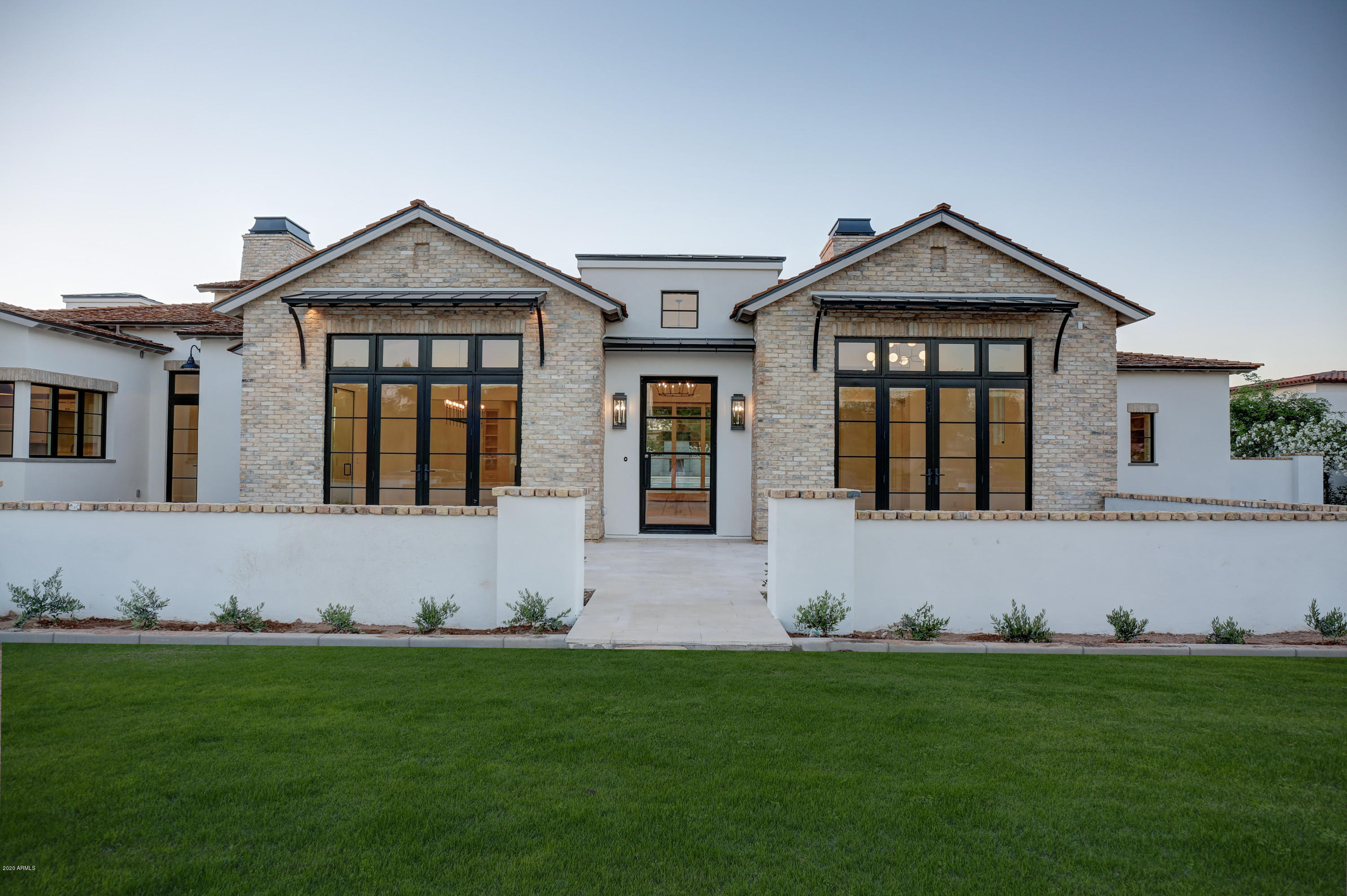 Modern Farmhouse new build from the team of Candelaria Design, Mullard Interiors, & Sticks & Bricks Dev. 7,000 SF single-level on a private street. 4 bed, 4.5 bath, 4 car garage, with office (5th bedroom), and game room/lounge. Premium features include: shake/metal roof, custom awnings, reclaimed brick, marble tops & floors throughout, artisan tile, wood clad windows & doors, wood floors, Subzero/Wolf appliances including 48'' range, duel 30'' fridge/freezers, multiple beverage fridges, 2 ice-makers, warming drawer, 2 dishwashers, walk-in pantry with separate steam and speed ovens, butlers pantry, conditioned wine wall at dining room, 5 fireplaces, built-in BBQ, with stunning Landscape/pool/spa design and an over the top outdoor pergola/conversation area.