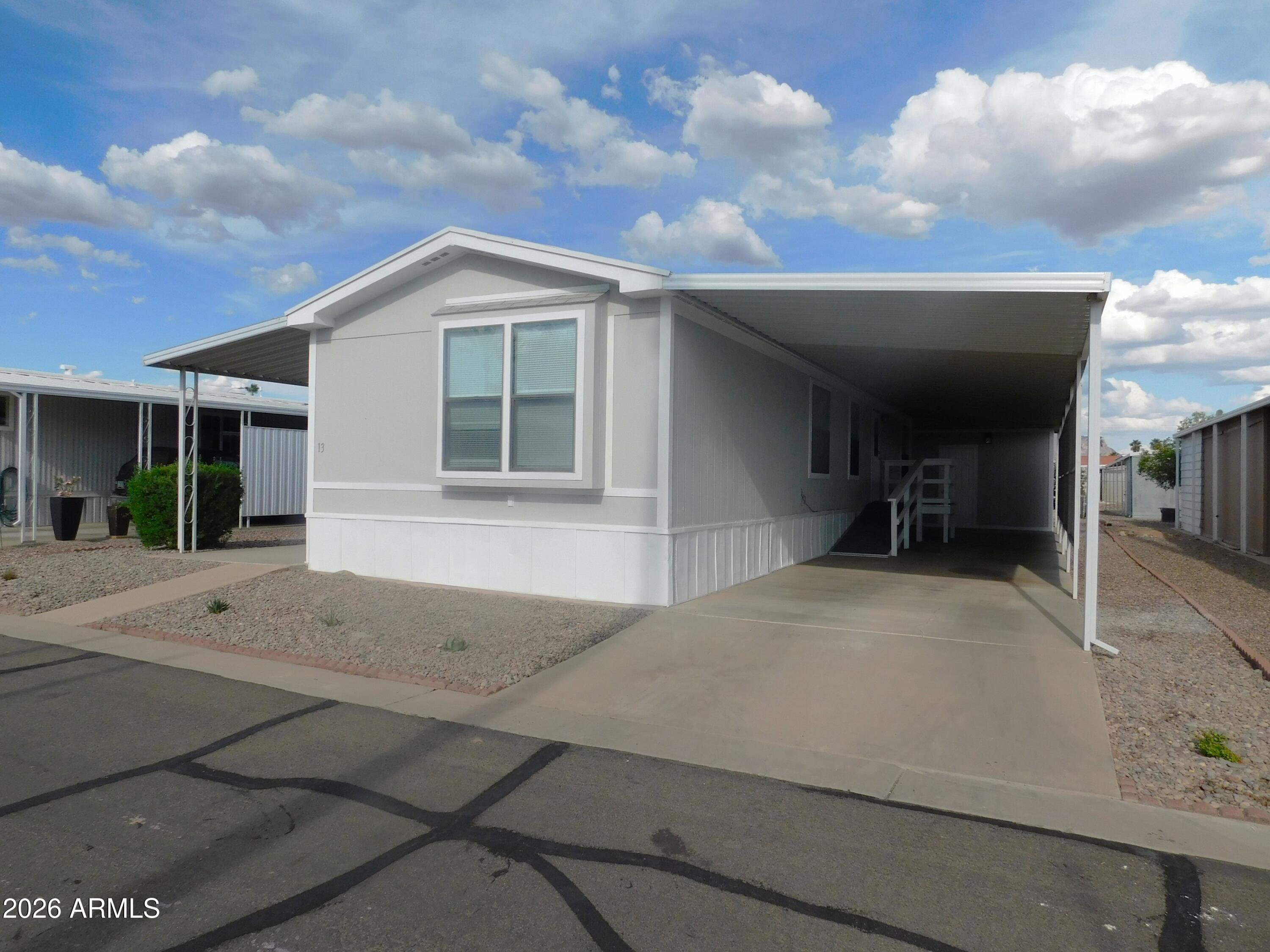 Welcome to a quiet, tight-knit retirement community offering stunning views of the Superstition Mountains and a true sense of Arizona living. Ideally located near Old West Marketplace, USPS services, KOA campgrounds, local saloons, and more! This community provides the perfect balance of peaceful surroundings while still being close to everyday conveniences. Enjoy an active lifestyle with community amenities including a heated pool, spa, clubhouse, and pickleball courts--perfect for embracing the retirement lifestyle.
This beautifully updated home features a highly desirable split-bedroom floor plan, offering maximum privacy with a bathroom for each bedroom. An accessible ramp under the shaded carport provides ease of entry, while additional exterior storage space is ideal for woodworking, crafts, or extra belongings.
Recent upgrades include new $12,000 Cortec flooring installed throughout for durability and low-maintenance living, along with fully remodeled bathrooms showcasing a bright, modern design. Electrical and plumbing systems have been updated, and new lighting and fixtures enhance the home with exceptional brightness throughout.
Don't miss this opportunity to own a thoughtfully updated home with a functional layout, modern finishes, and breathtaking mountain views in a welcoming community!