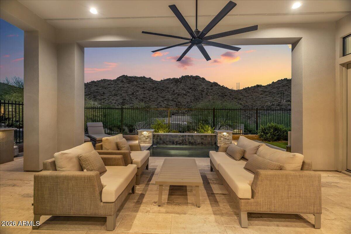 Camelot custom home in Adero Canyon with stunning VIEWS ! of the McDowells,  Red Mountain, & the Superstitions, this Camelot home features every upgrade offered, including 12-foot ceilings and modern design create a bright, open great room with seamless indoor-outdoor flow. The gourmet kitchen has Wolf &  SubZero appliances, a large quartz island, and elegant finishes. With 2 bedrooms, 2.5 baths, and a flexible den, the layout balances comfort and function. Highlights include 8-foot solid core doors, hardwood floors, and a striking rotunda entry. The spacious primary suite offers a sitting area, patio access, and spa-like bath including steam. A private guest suite, stylish powder room, and tranquil backyard with covered patio, BBQ, cocktail spool & mountain views complete the home