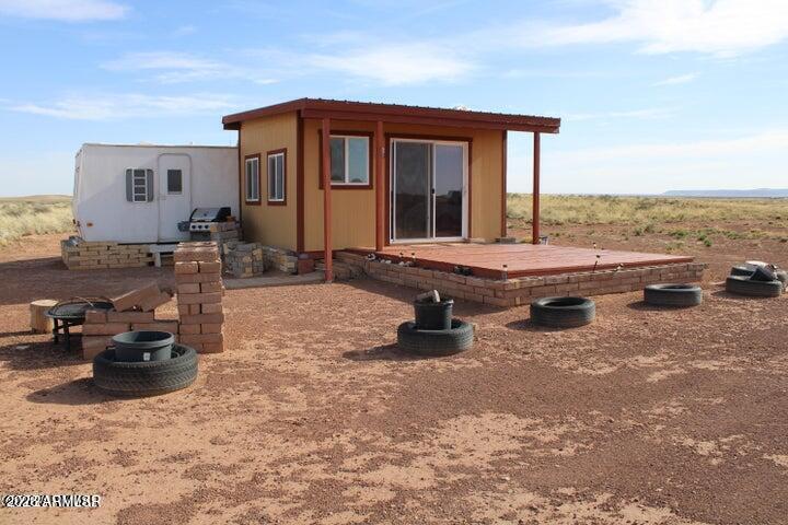 This fenced 38.87 acre has a Well with a pump & generator. There is a 30' Dutchman RV set up on the property. The RV has block skirting & is tied down. A 15' x 16' room addition completes the living space. It includes a 15'x15' storage shed. A Solar system supplies the power with a 1500 W inverter & includes 2 large storage batteries. It features incredible panoramic views & vast open space. Very well done.
