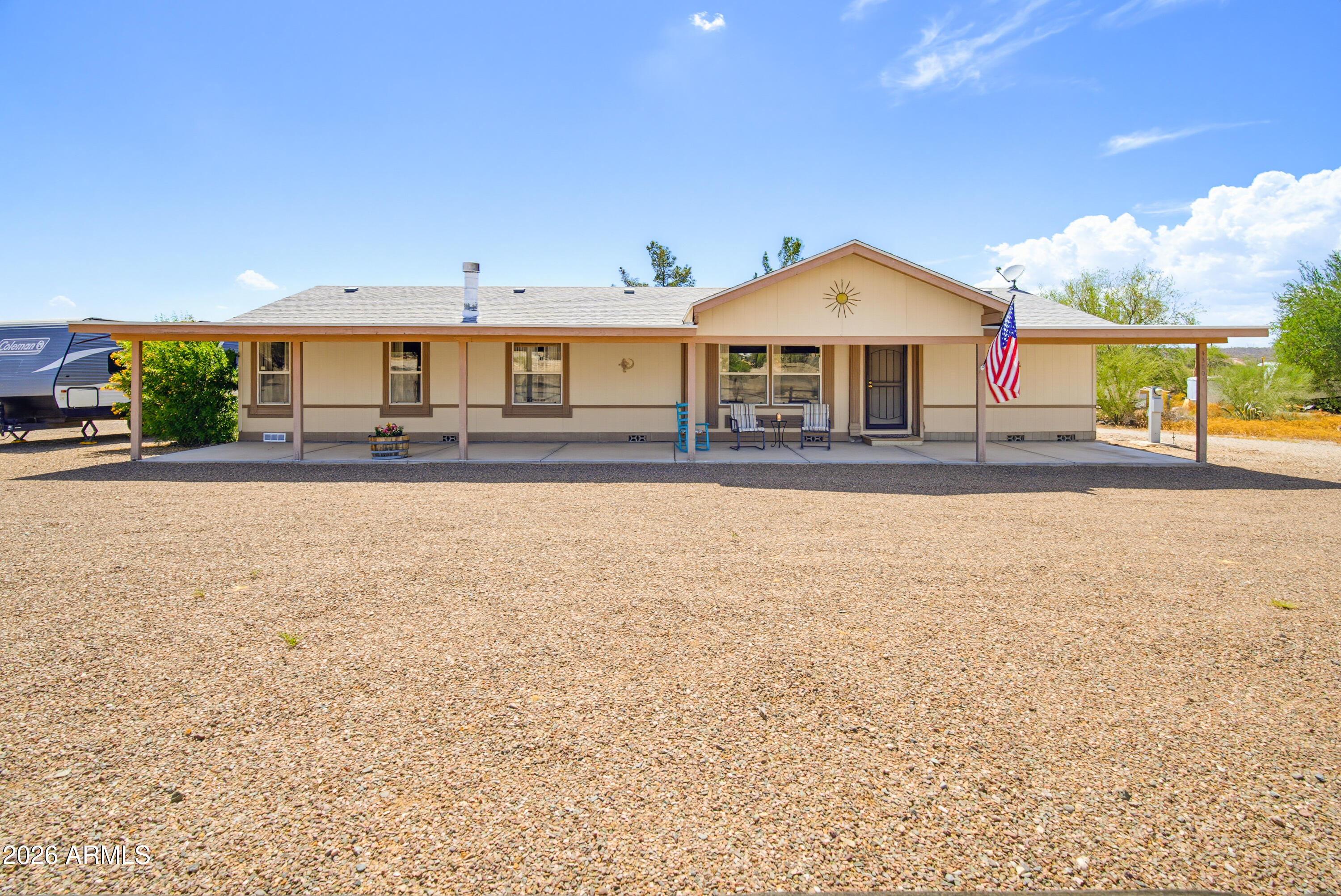 Enjoy the Mountain Views from the Covered Patio of this Move In ready Home on 1.5+ Acres!Very Spacious house with 1848 Square Feet with a Split Floor Plan! This Property has No HOA, Shared Well, 3 Separate Storage Units, 2 Covered Patios that Span the Length of the Home Front & Back. Nice Sized Primary Bedroom  With a Large Walk-In Closet, Bathroom  Includes a Garden Tub, Separate Shower & Double Sink Vanity. The Kitchen Has Updated Painted Cabinets, Kitchen Island & Plenty of Storage. The Flooring has been Updated in the Main Traffic Areas With Laminate (Wood Plank Look). Bring Your Toys. Plenty of Room on this Lot For Additional Structures! Enjoy The Privacy This Property has to Offer!