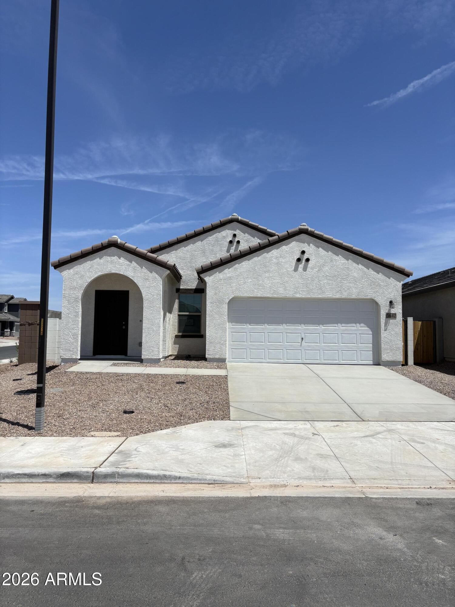 Introducing a stunning new build on a premium corner lot in sought-after San Tan Valley, ready this May. This home blends modern design with desert serenity, offering elevated finishes such as 9' ceilings, designer tile flooring, granite kitchen surfaces, GE stainless steel appliances, and crisp white cabinetry. Smart, energy-efficient features enhance comfort and convenience.
The owner's suite boasts a generous walk-in closet, while the covered patio and professionally landscaped front yard create inviting outdoor spaces. Minutes from scenic trails and mountain vistas, this community is planned to include resort-style amenities: a sparkling pool, splash pad, sports courts, playgrounds, pocket parks, walking paths, and a full community center with fitness facilities. Ideally positioned near Queen Creek's schools, shopping, and dining.