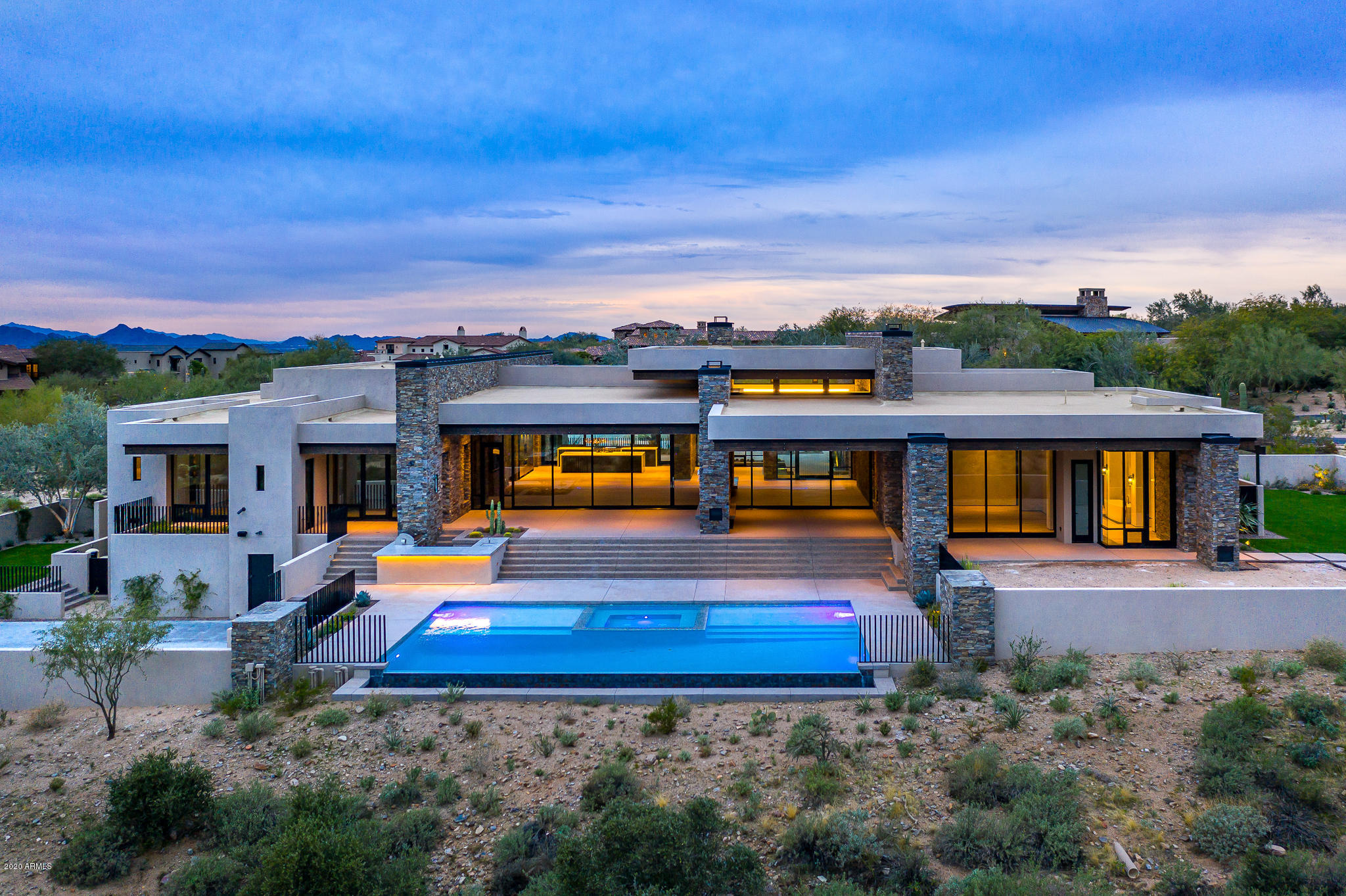 Highly anticipated in the Country Club of DC Ranch, a new Archer Custom Contemporary. Perfect size, single story, ideal location and views. The 7,208 SF open plan flows seemlessly from large great room, kitchen and dining room to the master suite/office on one side, 4 en suite beds/bonus room on the other, and the 6th bedroom a private guest casita. Walls of glass bring the outside in, effortlessly. The use of stone and quality finishes create a modern yet comfortable setting. The outdoor spaces are well thought out with expansive covered patios, kitchen, large pool/spa, fire pit, grassy areas and additional space for a sport court, all backing to open space and picturesque mountains. The drama of the views and the equally dramatic home are a must see for those that appreciate the finest.