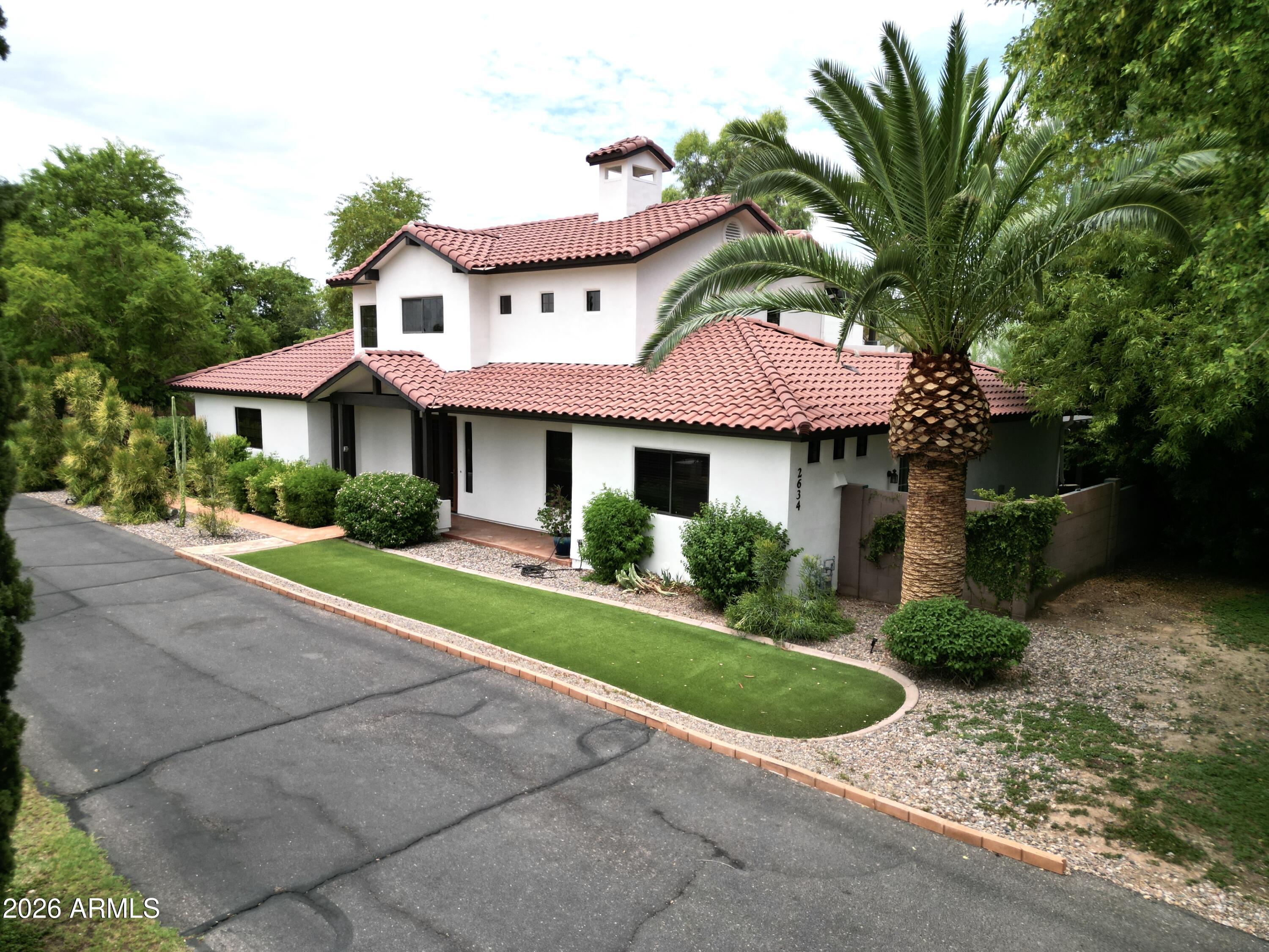 UNICORN ALERT....no, really, this one is special! This private, gated compound is perfect for those looking for a quiet oasis in the city with spectacular views of Camelback from the upstairs deck. Pull thru the gates, drive down the long paved driveway, past the mature trees, football sized grassy area and come around to the 3 car garage. Walk inside and be greeted with a large living room, gorgeous kitchen, bedroom and bath plus a attached casita all on the main floor. Upstairs is the open den and the primary bedroom. Be wowed by the views simplicity of this estate. Fun times await on the huge covered patio looking over the large pool area, cabanas, large trees and feel like you are on vacation. This one is really special and needs a buyer of equal caliber. Come see why it is a unicorn!