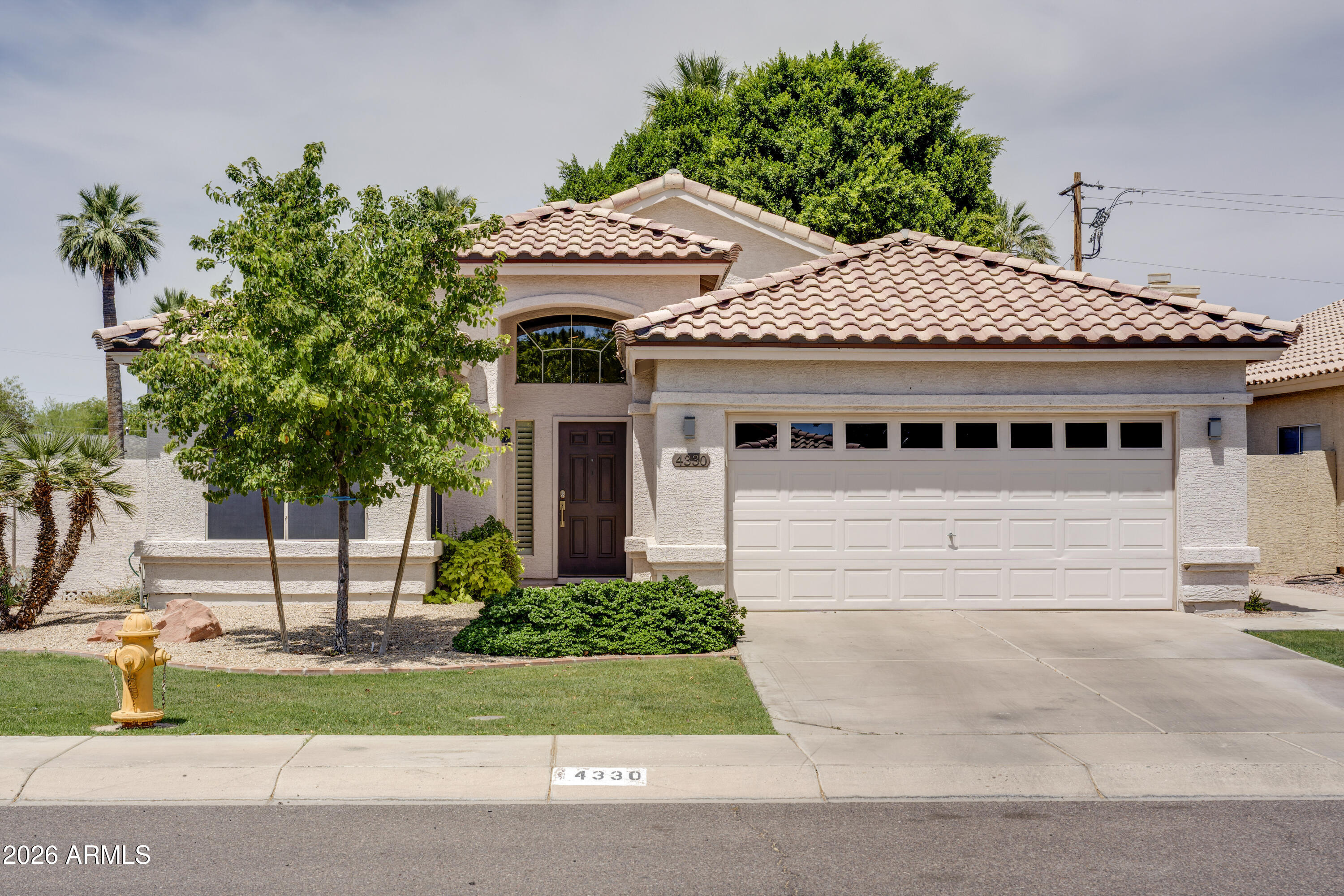 If you are looking for move in ready - this meticulously maintained home in Arcadia Lite is for you. Featuring an open-concept floor plan with wood-look tile flooring, neutral finishes, and a fireplace in the main living space. Previous owner did whole house & pool remodel in 2019. Kitchen includes Frigidare Professional stainless steel appliances, cabinetry, and an eat-in breakfast area. RO system and water softner. Spacious primary suite with en-suite bathroom and custom closet built-ins. Backyard offers a private pool with detachable safety fencing and mature landscaping. Additional highlights include a 2-car garage and corner lot location. Recent updates also include a new AC, furnace and Captura air purifier (2023), water heater (2022) and updated electrical panel (2024)