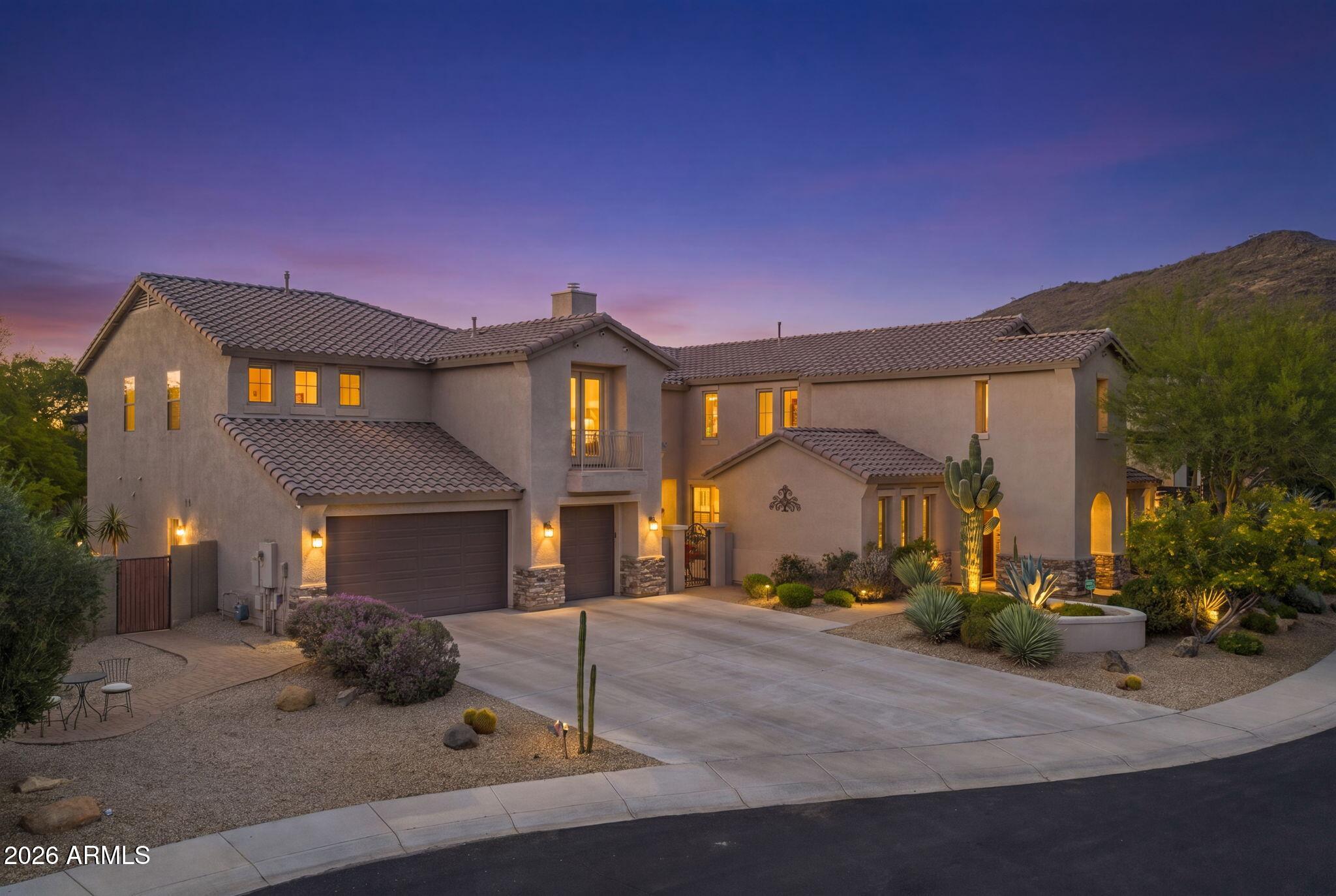Ultimate Anthem privacy meets resort-style luxury at 38809 N Courage Court. Welcome to this spectacular 5,148 sq. ft. Spirit model, perfectly situated on a rare 1/3 acre cul-de-sac lot with only one neighboring home and a beautiful wash backdrop for exceptional privacy, scenic desert views, and a peaceful Arizona setting. From the moment you arrive, the home makes a memorable impression with custom double iron front doors, a gated pavered courtyard, and an inviting outdoor gas fireplace.
Inside, the thoughtfully designed floor plan is ideal for everyday living and upscale entertaining, featuring brand-new wood luxury vinyl plank flooring throughout, 5 spacious bedrooms, 4.5 baths, a private den, and a desirable main-level guest suite ideal for multigenerational living, visiting guests, a private workout room, or nanny/in-law quarters. The remodeled modern kitchen is the heart of the home, showcasing a high-end marble backsplash, updated hardware, granite countertops, stainless steel appliances, and a massive center island that opens seamlessly to the family room with its own cozy gas fireplace.
Upstairs, two staircases lead to a spacious second level featuring 4 bedrooms and an expansive bonus room, perfect for a playroom, lounge, game room, or flex space. A dramatic spiral staircase leads exclusively to a permitted 237 sq. ft. addition, bringing the total square footage to 5,148 sq. ft. Designed as a private custom home theater, this impressive space is complete with premium reclining seating, a high-end projector system, and immersive Dolby Atmos surround sound.
The remodeled primary suite offers a peaceful retreat with a spa-inspired bathroom featuring an oversized walk-in rain shower, deep soaking tub, dual vanities, and a large walk-in closet. Step outside to an ultra-private backyard oasis framed by mature trees and lush landscaping. Designed for year-round Arizona living, the resort-style yard features high-end Italian travertine, a heated pebble sheen pool, a 12-person spa, synthetic turf, a custom outdoor gas fireplace, a spacious covered patio, and a built-in outdoor island with a premium KitchenAid BBQ grill.
With unmatched privacy, flexible living spaces, luxury upgrades, a private theater, resort-style backyard, and access to Anthem's parks, trails, pickleball courts, recreation, shopping, dining, and community amenities, this private Anthem oasis truly has it all.