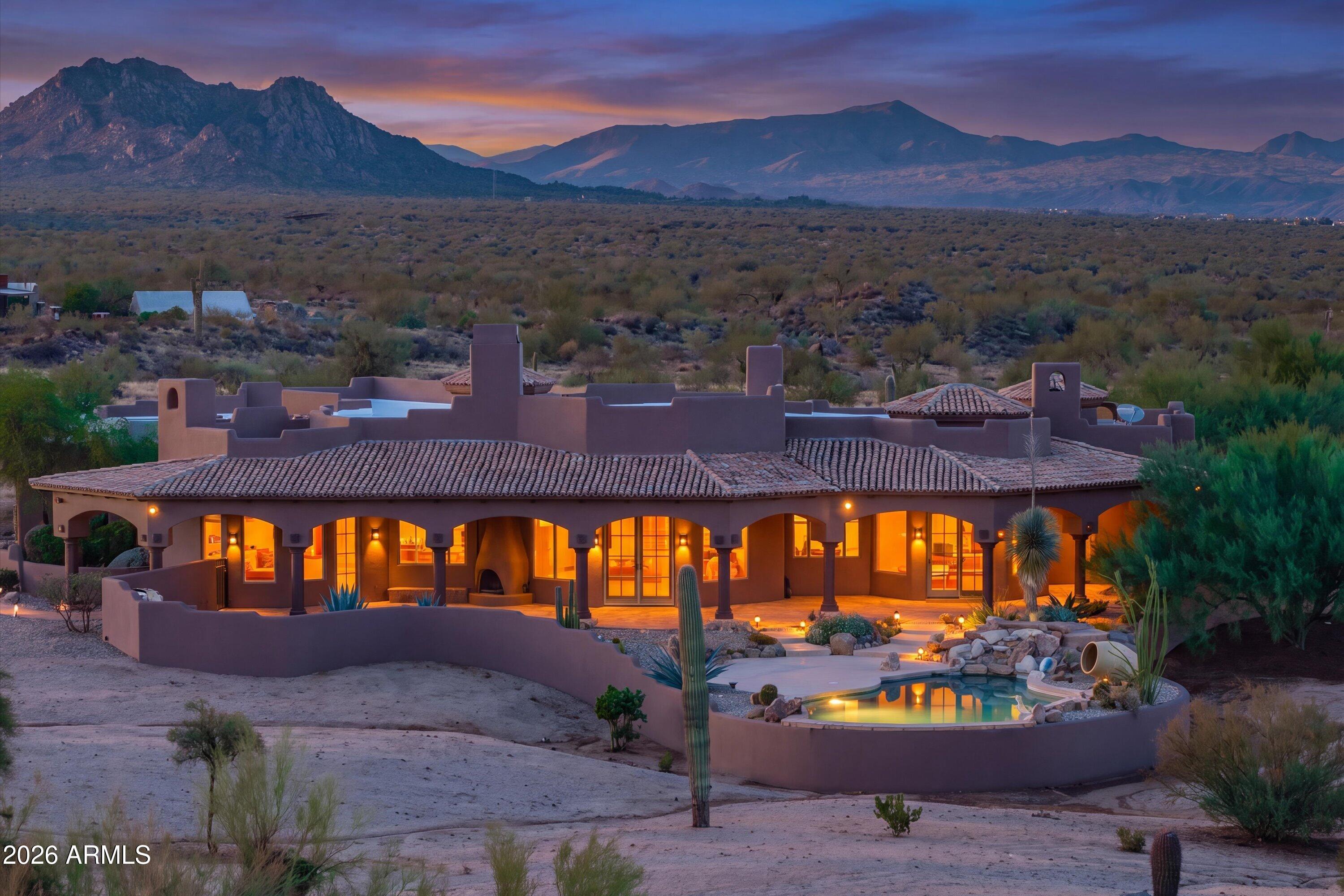 Extraordinary Desert Equestrian Estate bordering the McDowell Sonoran Preserve. Set on
approximately 14 pristine acres at the end of 132nd, a quiet paved road, this exceptional custom residence
captures panoramic views of the McDowell Mountains and the untouched beauty of the Sonoran
Desert. Designed to blend seamlessly into its natural surroundings, the home offers soaring
ceilings, expansive windows, rich wood and stone accents, multiple fireplaces, and spacious living
areas that invite both comfortable everyday living and unforgettable entertaining. Equestrians will
appreciate the outstanding horse facilities, highlighted by a 300' x 150' arena, quality barn with 12 covered horse runs, Auto waterers,  hot walker, wash rack, and direct access to miles of scenic riding trails.  MOR Whether you're a serious competitor or simply enjoy the ranch lifestyle, this property offers a rare
combination of functionality and beauty. Outdoor living is equally impressive with a heated pool and
spa, generous patios, built-in BBQ, and spectacular Arizona sunsets in every direction. A large
unfinished basement provides exciting possibilities for a wine cellar, fitness studio, home theater, or
additional living space. A valuable recent improvement is the installation of a new high-producing
private well, providing dependable water service and enhancing the long-term value of the property.
Offering exceptional privacy, breathtaking scenery, and one of North Scottsdale's most desirable
equestrian settings--just minutes from world-class golf, dining, shopping, and Scottsdale
Airport--this is a rare opportunity to own an extraordinary desert estate.
" Approximately 14-acre private estate bordering the McDowell Sonoran Preserve
" Custom residence with approximately 4,764± square feet
" Spacious open floor plan with soaring ceilings and abundant natural light
" Rich stone and wood architectural details
" Multiple fireplaces
" Heated pool and spa
" Built-in BBQ and expansive outdoor entertaining areas
" 300' x 150' arena
" Barn with covered horse runs
" Hot walker and wash rack
" Direct access to extensive riding trails
" Large unfinished basement with expansion potential
" New high-producing private well
" End-of-road privacy with panoramic mountain and desert views
" Minutes to North Scottsdale amenities while enjoying complete serenity