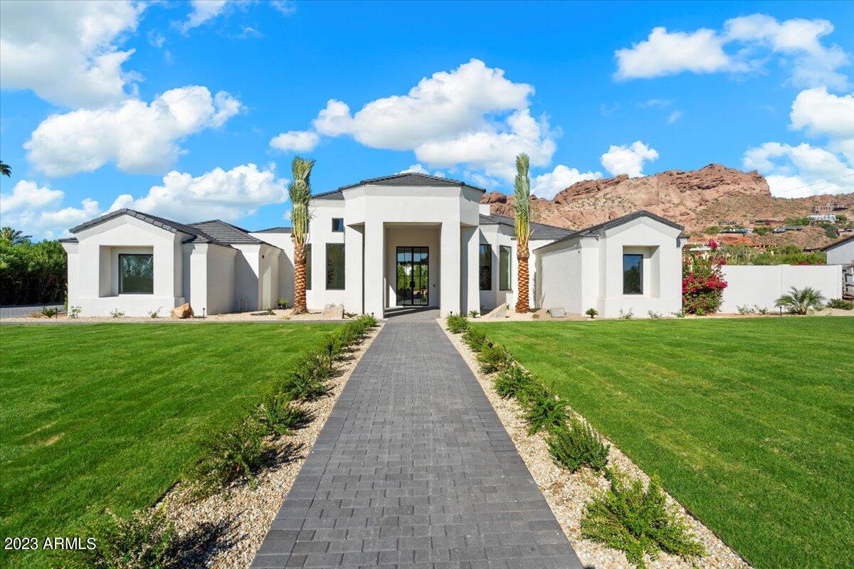 Experience Camelback Mountain views from this newly completed residence by Norton Luxury Homes. Offering 4 Bedrooms, 6 Bathrooms and nearly 5,500 Sq Ft, this gorgeous single level property on almost an acre, features a neutral and bright design throughout, tall ceilings, located in one of the most sought after neighborhoods. The Kitchen features Sub Zero and Wolf appliances, custom cabinetry and a large island. The primary suite features a marble fireplace, bathroom with dual vanities/dual water closets and a spacious closet with washer/dryer! All of the bedrooms are generously sized ensuites. The property offers a 4 Car Garage, separate office and game room! The large backyard features a pool bathroom, covered patio space, and mature ficus trees. Backyard to be completed within 45 days.