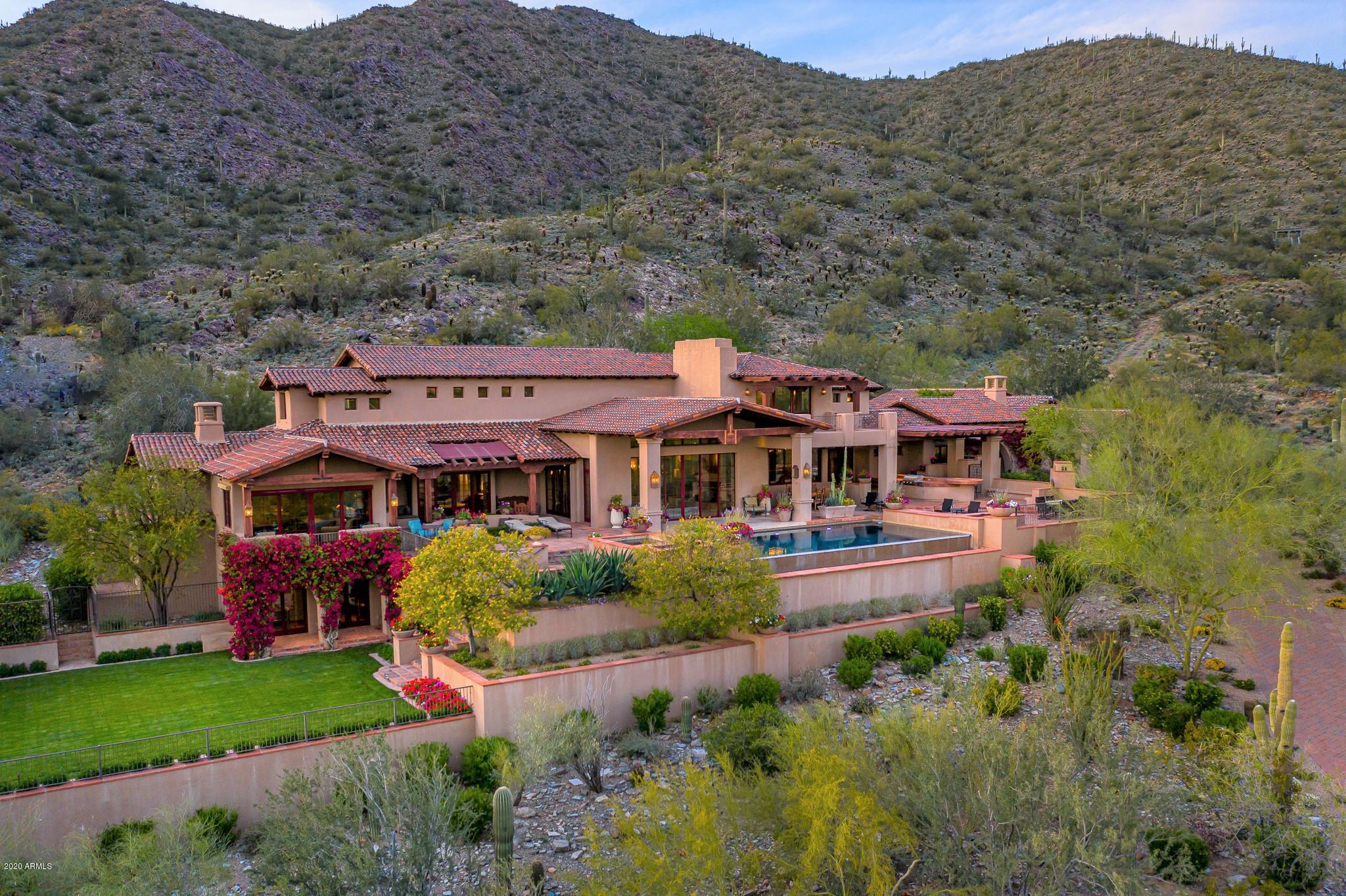 One of the most dramatic golf course and city light views in the Upper Canyon of Silverleaf.  A tree lined private drive leads to this stunning ranch hacienda estate,  perfectly positioned on an elevated, south facing hillside lot.  Automated sliding doors blend the indoor and outdoor living spaces with ease, home theatre, large fenced grass area and separate guest casita create a resort like feel. The spacious and dramatic outdoor entertaining area includes: an infinity pool, water and fire features, built in patio heaters, outdoor kitchen and dining room.  Unparalleled views of the city, golf course, and mountain preserve make this estate a rare opportunity to enjoy the best of Arizona living.