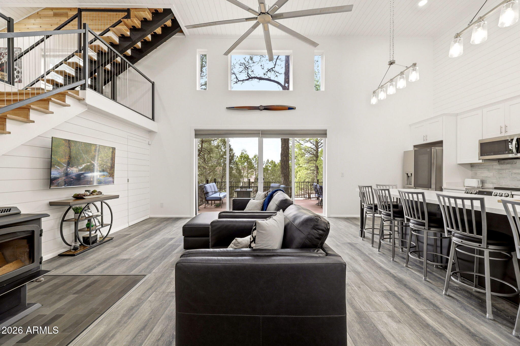 Turn-key, thoughtfully reimagined and fully converted airplane hangar in the private Mogollon Airpark, this modern mountain retreat
offers rare runway access and exceptional versatility. The 34'+ x 43'+ hangar pairs with ~1,900 sq ft of finished luxury living space,
featuring soaring ceilings, 2 bedrooms, 2 bathrooms, a loft, bonus room, laundry, and a hidden secret closet. Enjoy the oversized
back deck and fully fenced yard, or open the hangar door to create a covered patio--ideal for relaxing in the spring rain. Perfect for
storing an airplane or ATVs, hosting a large gathering or cozying up alone by the wood-burning stove, this one-of-a-kind property
being offered furnished truly has something for everyone. Enquire for your private tour today!