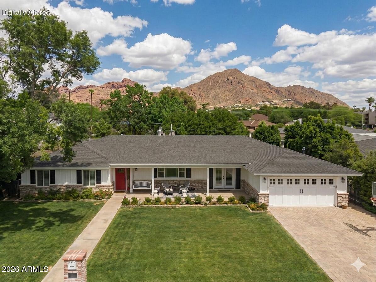 Welcome to this stunning Arcadia ranch-style family home, thoughtfully rebuilt by Rafterhouse with exceptional craftsmanship and design. From the moment you enter, you're greeted by vaulted ceilings and striking exposed wood beams that create a warm yet sophisticated focal point. Designed with both comfort and entertaining in mind, the home features an open-concept floor plan filled with natural light. The chef's kitchen is a true centerpiece, showcasing crisp white cabinetry, a generous island, stainless steel appliances, wine refrigerator and a walk-in pantry. The split primary retreat offers a private sanctuary, complete with vaulted ceilings and a spa-inspired bathroom featuring marble countertops and flooring, a soaking tub, large shower, and an expansive walk-in closet. With four bedrooms, three and a half bathrooms, and a dedicated game room, the layout provides flexibility for modern living. The outdoor space is designed for effortless entertaining, featuring a sparkling pool, built-in grill, and inviting fire pit, ideal for enjoying Arizona evenings. Situated on a quiet cul-de-sac in the heart of Arcadia the perfect place to enjoy family and friends. 
This is Arcadia living at its finest.