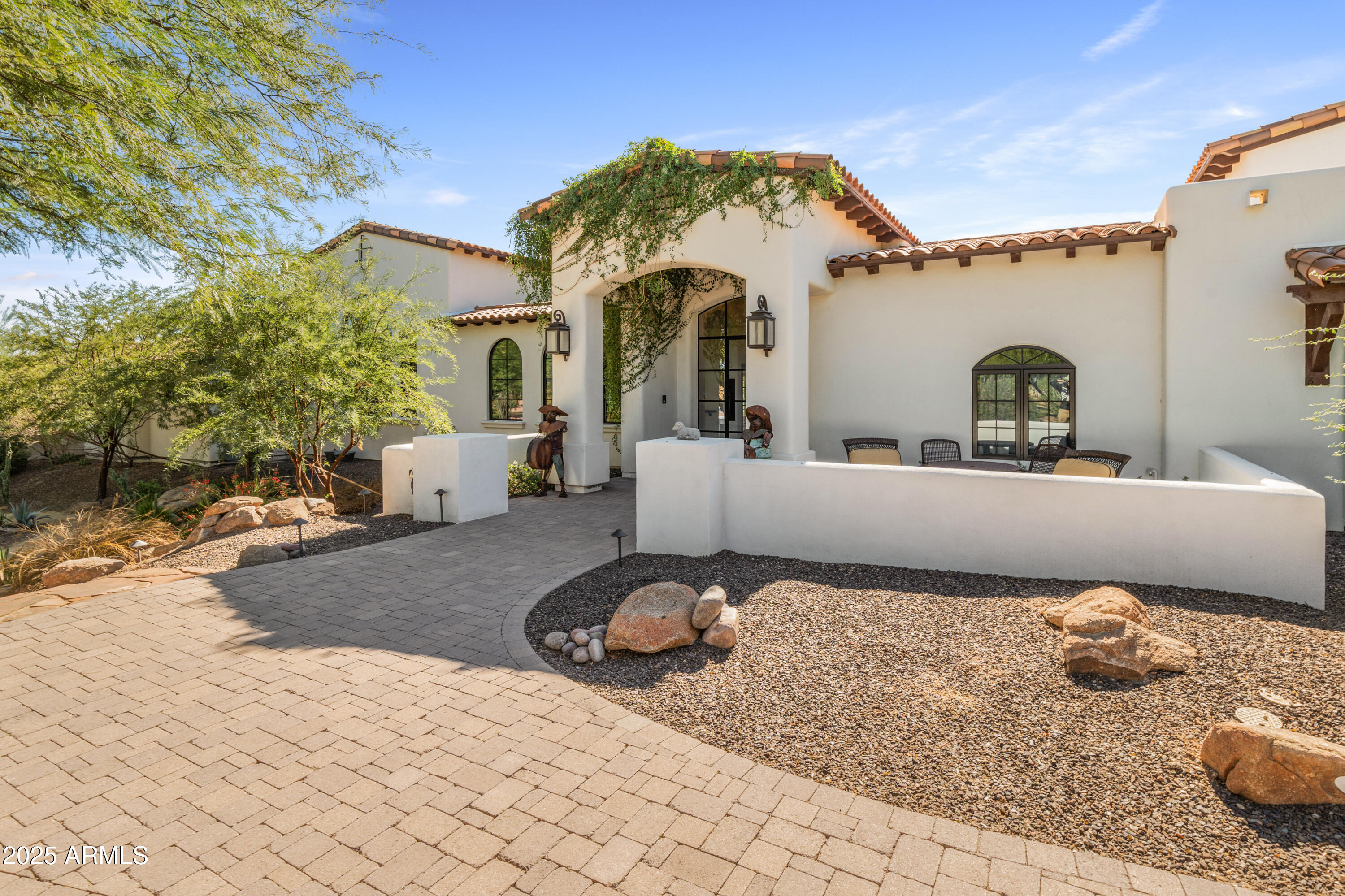 This beautiful home of almost 7000 sq ft located in the heart of Paradise Valley, is an entertainers delight. In 2022 with the addition of over 3000 sq feet to the original homes footprint, the design team at Legacy Remodeling have created an exceptional home that boast both luxury and comfort. As you enter the home you are greeted by a beautiful outdoor courtyard with a fireplace and water feature both imported from France. No detail has been overlooked in this stunning kitchen with butler pantry. From the Wolfe, Cove and Subzero appliances to the bookmatched quartzite countertops, this dream kitchen has it all. The formal dining room located off the kitchen has wall to wall sliders on 2 sides of the room that open all the way to give you the feeling of dining al fresco Take the elevator or stairs to the primary suite, with a balcony and gorgeous views of Camelback Mountain and the infamous Praying Monk. The primary bathroom has a washer and dryer conveniently located so no need to bring laundry up and down. The oversized steam shower is the highlight of the bathroom. The original homes footprint has 2 bedrooms along with a very large family room with a wood burning fireplace and game room. A new wine room was built with glass doors and a high top table to entertain your friends and family. The home also has a greenhouse room for indoor gardening.

The backyard has a large outdoor cooking area and bar with plenty of seating. There is a putting green, pool and a ramada with an outdoor fireplace along with another gas firepit with bench seating around it. Enjoy the stunning views of Camelback Mountain and the beautiful Arizona sunsets while outdoors in this relaxing and serene backyard.