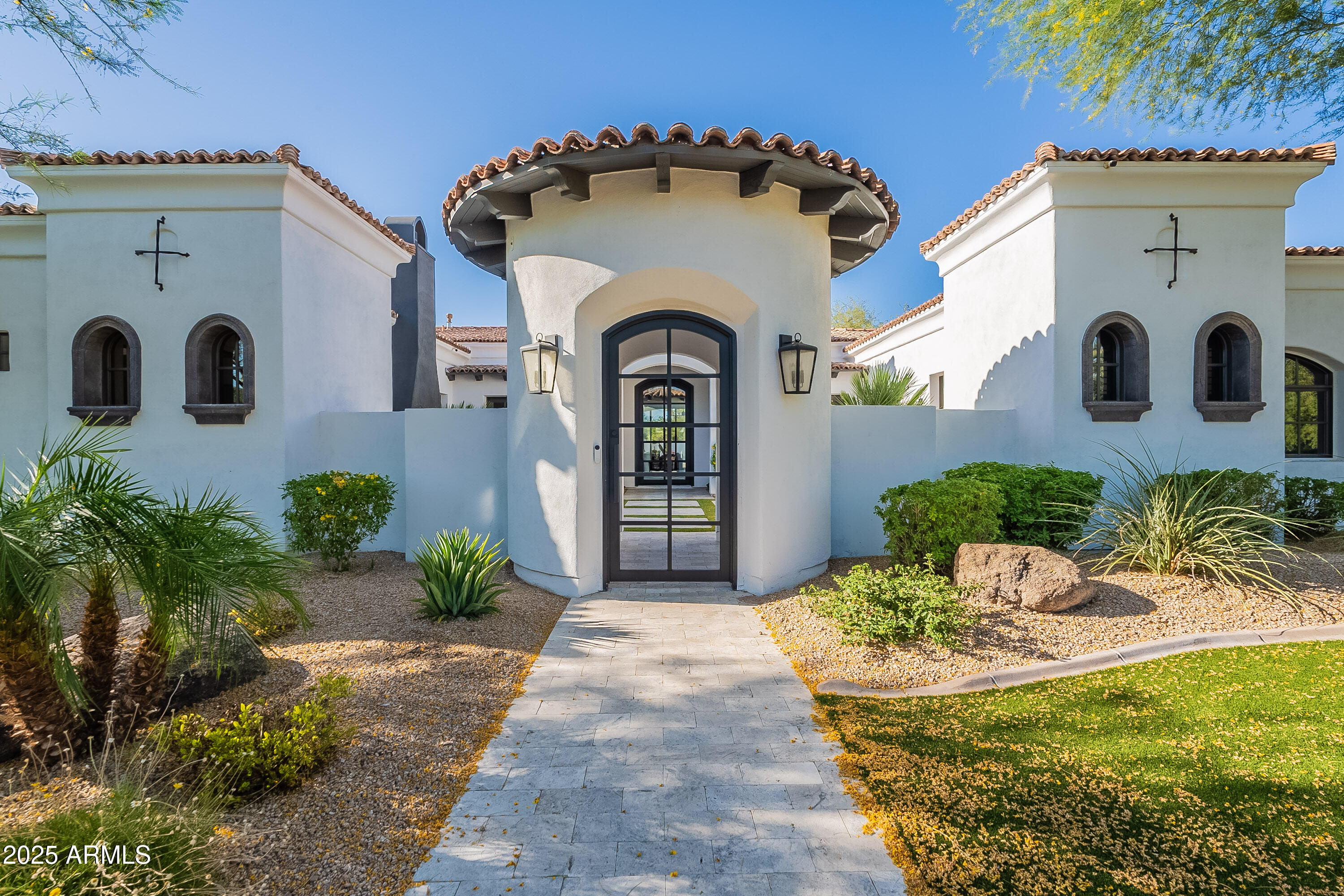 Welcome to a masterpiece of modern luxury, where timeless Mediterranean elegance meets contemporary sophistication. Nestled on an expansive 1.012-acre lot (44,103 sq. ft.) in the heart of Paradise Valley, this originally built in 2006, and meticulously updated in 2022, 6,388 sq. ft. estate, encompassing a stunning main residence and a charming detached guest house, redefines opulent living. With 5 bedrooms, 5.5 baths, and an array of unparalleled amenities, this home is designed for those who cherish style, comfort, and grand entertaining.

From the moment you approach, the circular driveway and lush, manicured landscaping set the stage for grandeur. A striking oversized glass front door opens to the main house, offering a serene prelude to the beauty within. Step in Step inside to discover rich hardwood floors, soaring ceilings, and designer lighting that illuminate every thoughtfully curated detail.

The heart of this home is its chef's kitchen, a culinary dream featuring sleek quartzite countertops, a dramatic waterfall island, and black leathered granite backsplash that extends to the ceiling. Equipped with premium Sub-Zero and Wolf appliances, this space seamlessly flows into a casual dining area and a formal dining room, perfect for hosting intimate dinners or lavish gatherings. Exposed wooden beams add warmth to the adjacent office/den, complete with French glass doors and a cozy gas fireplace, creating an ideal retreat for work or relaxation.

Designer touches abound, from floor-to-ceiling decorator tile in the spa-inspired bathrooms to custom lighting fixtures that elevate every room. A spacious bonus room and an oversized laundry room with ample storage, featuring pedestal washer and dryer, ensure functionality matches form.

The detached guest house is a haven of its own, offering a full kitchen, living area, bedroom, and bathroom perfect for visitors, extended family, or a private studio. This versatile space enhances the estate's appeal for multi-generational living or hosting guests in style.

Step outside to a backyard that rivals a five-star resort. The expansive outdoor living area is designed for unforgettable gatherings, featuring a double barbecue under a shaded pergola, a built-in gas fire pit, and a professional-grade pickleball court. Dive into the large pool with cascading water features, unwind in the attached hot tub, or perfect your swing on the artificial turf putting greenno mowing required. Lush landscaping, mature palms, and towering trees create a private oasis, while the meticulously designed hardscape ties it all together.

Every inch of this estate has been thoughtfully updated, from the front curb to the back wall. With a lot size exceeding an acre, this property offers rare space and privacy in Paradise Valley. The combination of contemporary finishes, Mediterranean charm, and resort-style amenities makes this home a true gem.

This home is also located in the 3 C's A+ Award Winning School District with Cherokee Elementary, Cocopah Middle School, and Chaparral High School!

This is more than a home it's a lifestyle. Ideal for those who love to entertain, this estate offers the perfect blend of elegance, comfort, and functionality. Don't miss the opportunity to own this breathtaking Paradise Valley retreat. Book your private tour today and experience luxury living at its finest.