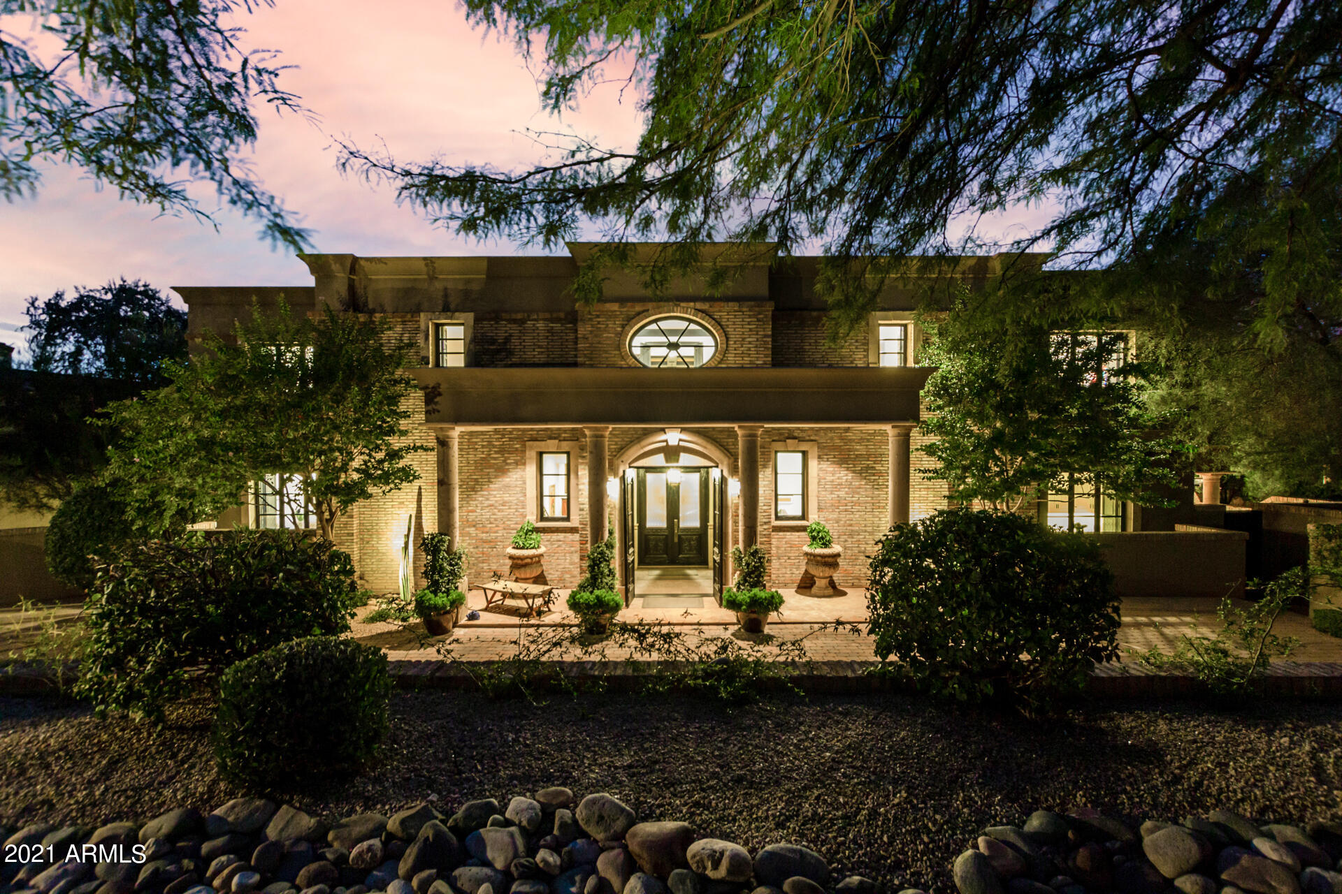 Set in an exclusive guard-gated community in North Scottsdale along Troon Mountain where ancient boulders tell a story...Where the builder spared no expense in creating a European villa masterpiece with the highest caliber construction available & unimaginable millwork/details...Where the grand foyer & entertaining areas take your breath away, & both the city lights & mountain views are enchanting. Current owner has remodeled/reinvented & invested extensively in almost every facet of the home. The chef's kitchen was completely remodeled & now incl. Dacor Modernist appliances (72'' fridge/freezer, 48'' range, 2 steam wall ovens, 2 dishwashers), Off the kitchen is a new wine room w/commercial-grade cooler, & huge Costco pantry. The home offers Inviting indoor & outdoor dining spaces, grand entertaining areas & fireplaces throughout. A new downstairs master suite was created w/custom closet/dressing area & soaking tub with window to Troon Mountain.  Upstairs the views are enchanting. There is a 2nd master suite upstairs, 2 additional ensuite bedrooms, exercise room, & professionally soundproofed theater w/true cinema lighting & decor.  Detached from the home is a 576 sq ft 2-room carriage house w/beautiful views & balconies. The resort pool/spa (resurfaced, new pump, dedicated pool bathroom) offers beautiful views and covered areas. The landscaping throughout the estate is extraordinary - a symphony of saguaros, ironwoods, palo verdes, orange, grapefruit & lemon trees, ocotillos, mesquites, succulents. Other improvements include all new HVAC units (Lennox), new roof w/warranty, home re-stuccoed & painted, new hot water heaters, new whole-house water purification. Please see list of upgrades & enhancements. The location of the home within Troon is exceptional & temps here usually 6-8 degrees lower than downtown areas. Walk to Troon Country Club. Less than 5-minute drive to Pinnacle Peak hiking trails & Four Seasons Resort, and only 8 minutes to AJs/Starbucks/Walgreens/Mastros. 13 minutes to the 101 Freeway.