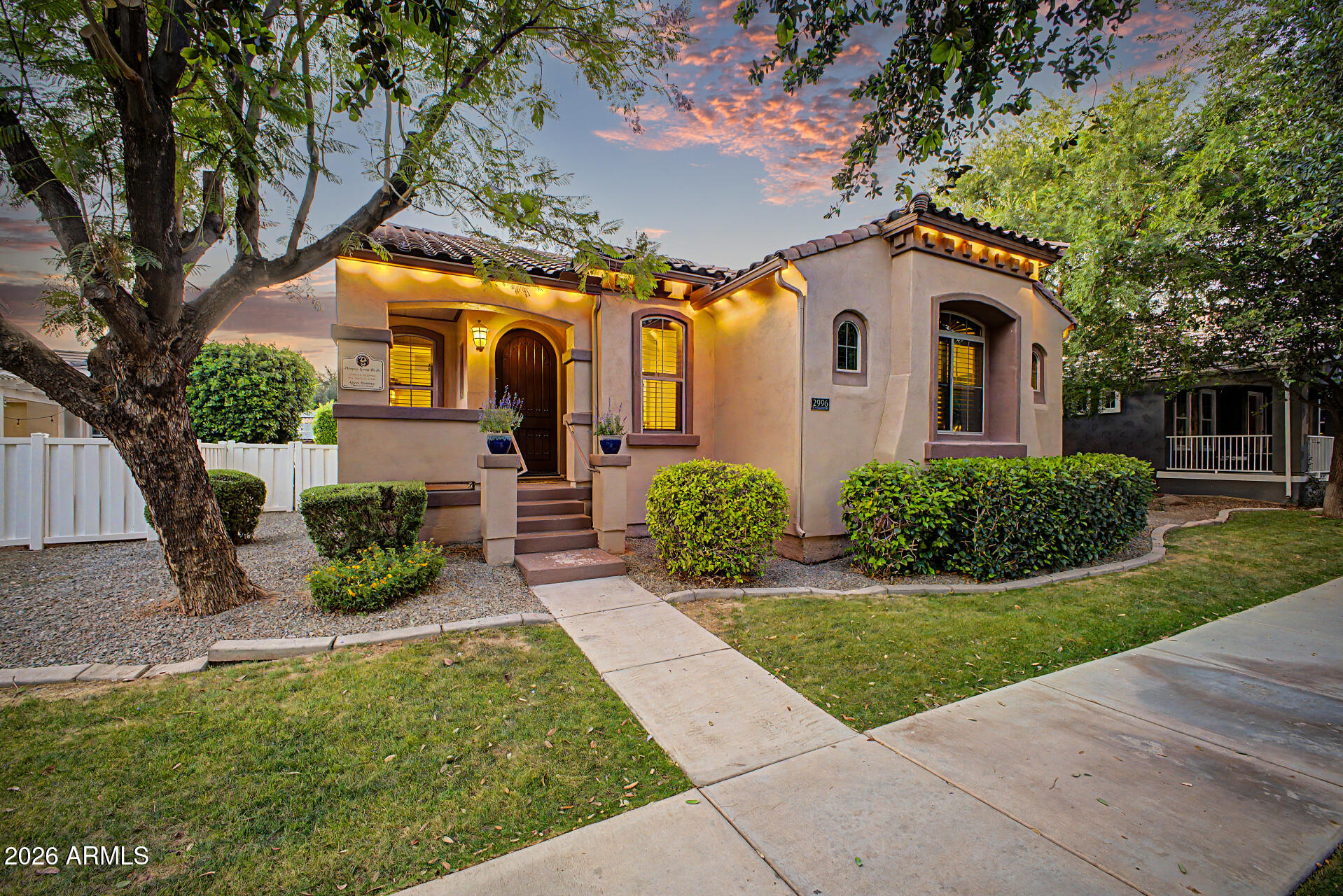 Nestled in the vibrant heart of Agritopia, this basement home captivates with its unique blend of charm, comfort, and an enviable lifestyle. These are just a few reasons why Agritopia is one of Gilbert's most sought-after neighborhoods. Spanning over 3,700 square feet, the thoughtfully designed living spaces invite you to experience both elegance and versatility. With four bedrooms, a finished basement, and seamless indoor-outdoor living, this residence is crafted for those who appreciate both style and function. From the moment you arrive, the inviting front porch, lush, mature landscaping, and undeniable curb appeal set a warm, memorable tone. Step inside to discover thoughtful architectural touches and inviting gathering spaces that radiate comfort and sophistication. The living room's two-way fireplace seamlessly connects to the family room, setting the stage for lively gatherings or peaceful evenings by the fire. The heart of the home is a stunning eat-in kitchen designed to spark creativity and connection. Granite countertops, custom cabinetry, recessed lighting, a travertine tile backsplash, sleek black appliances, and ample prep space make this kitchen both functional and beautiful. Whether hosting casual family meals or unforgettable celebrations, the open layout flows effortlessly into the family room, creating a welcoming hub for every occasion. The owner's suite is a private sanctuary, offering an ensuite bathroom with dual vanities, a luxurious jetted tub, a spacious walk-in shower, and a generous walk-in closet. Every element is thoughtfully designed to provide comfort, seclusion, and pure relaxation. Downstairs, the expansive basement transforms this home into an entertainer's paradise. Enjoy an entertainment zone, a stylish wet bar, a ready-to-go projector setup, two additional bedrooms, a full bathroom, and a versatile bonus room perfect for a home office, gym, playroom, or creative studio. This flexible lower level is ideal for lively game-day parties, cozy movie nights, or welcoming long-term guests. Step outside into your own private backyard oasis, the epitome of Arizona living. The resort-inspired space boasts a shimmering blue pool, a shaded deck, a built-in grill, and multiple inviting areas for relaxation and entertaining beneath the vast desert sky. The detached rear-entry extended garage accommodates three vehicles and provides abundant attic and cabinetry storage for ultimate convenience. Beyond the home, living in Agritopia brings an urban-farm lifestyle. The neighborhood centers on community, walkability, and connection. Residents enjoy tree-lined streets, community gardens, neighborhood events, parks, coffee shops, and neighborhood dining. Highly rated schools, shopping, entertainment, and the Loop 202 freeway are all close by. Opportunities to own a home of this caliber in such a coveted location are truly rare. Here, you will enjoy a distinctive lifestyle with modern amenities, a finished basement, and a resort-style backyard. Seize the chance to claim not just a home, but an extraordinary way of life in one of Gilbert's most iconic communities.