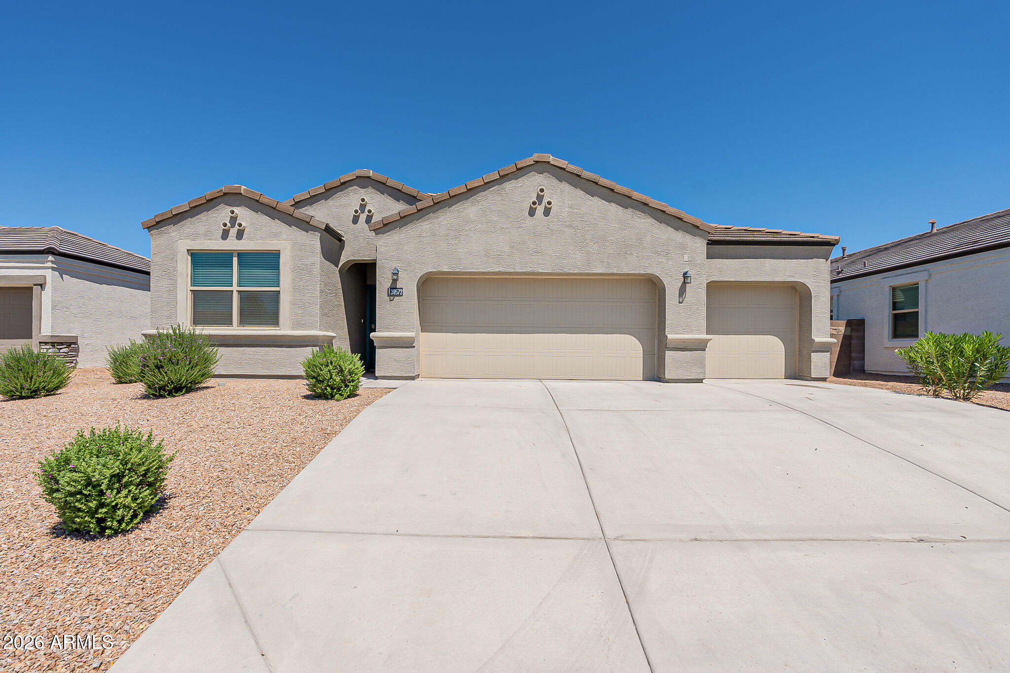 Welcome home to this beautifully maintained 4-bedroom, 2-bath residence in Buckeye that's move-in ready and designed for comfortable living! The open-concept floor plan features stylish tile flooring throughout the main living, dining, and kitchen areas, creating a bright and inviting space perfect for everyday living and entertaining.

The modern kitchen is a true centerpiece, complete with stainless steel appliances, granite countertops, a spacious island with seating, and a generous pantry for extra storage. The split-bedroom layout offers added privacy, with the spacious primary suite featuring dual vanities, a walk-in closet, and a private en-suite bath.

On the opposite side of the home, you'll find three well-sized guest bedrooms with ample closet space and a full guest bathroom The convenient laundry room includes a washer, dryer, and built-in shelving, while the oversized three-car garage provides plenty of room for vehicles, storage, or hobbies.

Step outside to enjoy the covered patio and low-maintenance front and backyard landscaping, offering the perfect space to relax or entertain without the upkeep.

With modern finishes, a functional layout, and move-in-ready convenience, this Buckeye home is ready to welcome its next owners. Schedule your showing today!