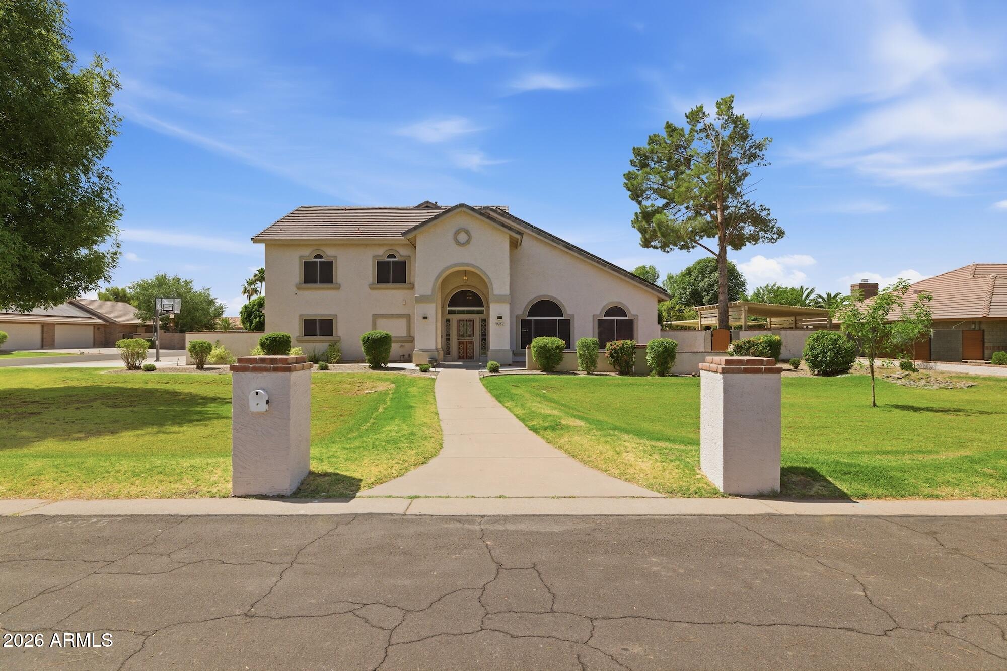 Set on nearly an acre in Mesa, this expansive property brings together the space of a large single-family residence, the flexibility of a private guest apartment, and the utility of a substantial RV garage/shop - all in one estate. The 4,667 sq. ft. main home offers 5 bedrooms, 3 full baths, and a half bath, with generous living areas, soaring ceilings, wood flooring, a curved staircase, and a bright, open kitchen designed for both daily living and entertaining.

The kitchen is appointed with premium Sub-Zero and Wolf appliances, including a 48'' Sub-Zero side-by-side refrigerator, Wolf wall oven, Wolf microwave, Wolf speed oven, and Bosch dishwasher. Updated lighting in the kitchen and basement, sun-blocking window screens on most windows, newer HVAC systems, water softener, two 50-gall water heaters and a 24-camera interior/exterior security system add comfort, efficiency, and peace of mind.

A separate 800 sq. ft. guest apartment expands the property's possibilities with 2 bedrooms, 1 full bathroom, a full kitchen, private laundry, and its own HVAC system - ideal for multigenerational living, extended guests, or a private work-from-home retreat.

Outside, the backyard is built for Arizona living. The resort-style pool area features expanded decking, a professional shade covering, poolside access gate, updated pumps, and a pergola area for BBQs and outdoor gatherings. An 8-person Jacuzzi spa, outdoor bathroom, refreshed landscaping, and updated fencing and gates make the yard equally suited for relaxing afternoons and lively evenings with friends.

For buyers who need serious workspace, storage, or vehicle capacity, the 2,100 sq. ft. RV garage/shop is a standout. It includes two 18' garage doors, a work room, office, and storage room, along with a dedicated RV parking pad offering 50-amp electric, water, sewer hookup, and a custom metal roof shade structure. A 220-volt EV charging outlet adds another layer of modern convenience.

With a spacious main home, separate apartment, resort-style outdoor amenities, security upgrades, RV infrastructure, and an oversized shop, this Mesa property offers a level of versatility that is difficult to replicate. Schedule your private showing and experience the full scope of what this property makes possible.