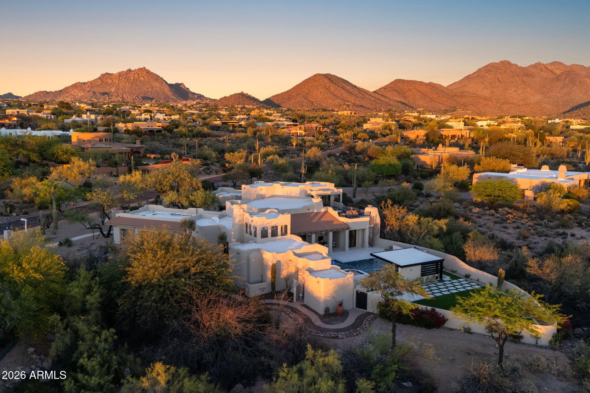 Two years in the making and finally arriving, this is the kind of property buyers wait for--and rarely see come to market. Perched on nearly two acres in the highly desirable Pinnacle Peak Vistas of North Scottsdale, one of the most sought-after areas in the Valley today, with unobstructed mountain and city light views, this one-of-a-kind residence has been completely transformed through a collaborative effort between an architectural team and interior designer--resulting in a true organic modern showpiece where every detail was intentionally crafted.

Taken down to the studs, the home features all-new systems, high-performance doors and windows, natural stone flooring, and custom white oak cabinetry throughout. The interiors are anchored by a refined, cohesive material palette... ...with sculptural fireplaces finished in limewashed Venetian plaster and thoughtfully curated textures that create warmth and depth. The chef's kitchen is outfitted with professional-grade Sub-Zero, Wolf, and Cove appliances, complemented by Rejuvenation hardware in uncoated burnished brass designed to develop a rich patina over time.

The expansive primary suite offers a true retreat with a spa-quality bathroom featuring elevated finishes and premium fixtures, while the secondary spaces continue the same level of design with designer tile and high-end materials throughout. A curated lighting package enhances each space, creating a layered and elevated living experience.

The outdoor living is a true showpiece, completely redesigned to match the level of the interior. Enjoy a resort-style pool and spa, sunken swim-up bar, and a covered pergola lounge with a cascading waterfall feature. A brand-new elevated party deck captures sweeping panoramic views of the desert, mountains, and city lights--creating an unforgettable setting for entertaining.

Ideally located in Pinnacle Peak Vistas, the property offers convenient access to world-class golf at Troon North, Grayhawk, and TPC Scottsdale--home of the renowned Waste Management Phoenix Open. Just minutes away, you'll find upscale dining, shopping, and entertainment at Kierland Commons, Scottsdale Quarter, and Market Street at DC Ranch, along with hiking at Pinnacle Peak and year-round events that define the Scottsdale lifestyle. All of this with remarkably low HOA dues of just $400 annually--an uncommon advantage for a luxury North Scottsdale community.

Two years in the making and now finally complete, this is more than just a home--it's a statement. A rare, architecturally driven North Scottsdale estate designed to impress, built for entertaining, and nearly impossible to replicate.