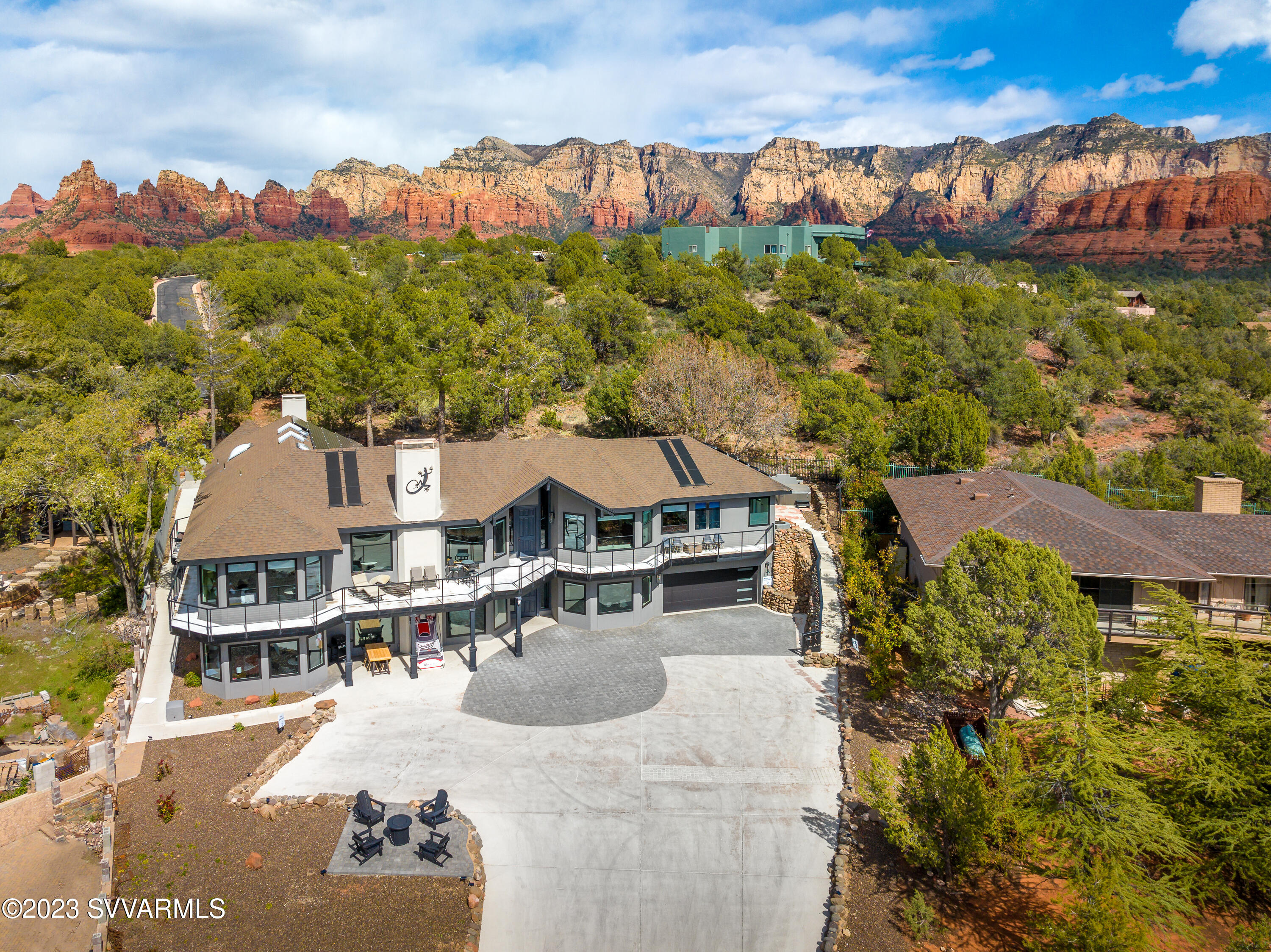 Everything you've ever dreamed of having in your luxury Sedona AZ retreat and more! 6,000+ sq ft extensively remodeled to the highest standards, sold fully furnished as pictured. 6 bedrooms + 2 bonus rooms, 7 bathrooms, 2 full kitchens + kitchenette. Tucked away in a quiet cul de sac with incredible red rock views, ample outdoor living space, hot tub, fire pits, grills, ping pong and parking for up to 10 vehicles. Close to the iconic Chapel of the Holy Cross, popular hiking trails & vortices. Currently a lucrative whole house - short term rental, reservations booked through 2024, RPA & VR Tour available. A picture is worth a thousand words, take your time viewing and envision the endless possibilities that await you at 50 Doodle Knoll. About this space
Have fun all in one stylish place, sleeping up to 22 with and including pull out queen beds. Entirely remodeled design of this home, new features, new furniture, new! EVERY detail of this luxury home: Full kitchen, Full size laundry room, 6 bedrooms and 7 stunning bathrooms, with 5 of them En suite. 
The space
Every inch of The Modern Sedona Retreat was lovingly curated and intricately designed to maximize guests' experience. THREE Separate wings (Suites) for big families or couples, to enjoy their own we comfort and relaxing get away.
Every part of this home has been lovingly curated with an intricate modern design offering our home that is nestled into the natural landscaping of the area, capturing the red rocks of Sedona, and offering shade, fresh air, and wildlife. 

~ Large Kitchen is fully stocked with everything you would need to cook with for a nice meal: pots and pans, plates, bowls, cooking utensils, silverware, cups, basic spices, bakeware, and more! We have a relationship with a chef that you could hire for personal use.
~ Two outstanding, UNIQUE coffee bars with a wide array of assortment coffees with Keurig maker and more to enjoy while you watch the sunrise from your bedroom window, or even during a relaxing night in the hot tub under the stars.
~ Three living rooms is equipped with a built-in floor-to-ceiling tile fireplace feature focal point where a 58" mounted t.v. above to enjoy your evenings relaxing on the oversized 3 brand-new sofa-SLEEPER sectional. Dining at the bar counter or having a more formal dinner at the table, has more than enough space to offer.
~In our Man/Kid Cave you can also watch the game (2) 60 Inch big screen TV, play a multitude of XBox 360 and Playstation 4 games, or enjoy some friendly competition as you challenge your friends and family to a game of basketball, shuffleboard, foosball, corn hole, and ping pong. If you want to play board games while you watch t.v. or prepare for an evening dinner with the family/friends





BEDROOMS

Bedroom 1 & 2 (2) Master suites (upper and lower level)  2 Plush QUEEN size beds and FULL bed in each master suite rooms. 55" HD Smart TV, DVD with large picture windows. The private Ensuite bathrooms are new tile marble shower with granite countertop vanities.

Bedroom 3 (upper level)  Plush queen size bed 55" HD Smart TV, and private access to a full shared bathroom with dual sinks and a marble shower.

Bedroom 4 (upper level)--- Plush King size bed with 55" HD Smart TV and a couch to sit on and look out at the views of the Vortex.

Bedroom 5 (lower level)- Plush king size bed with Ensuite bathroom fully re-done with new tile and floating vanities.

Bedroom 6 (lower level)  Plush King bed, 55" HD Smart TV, and private access to a full shared bathroom with a marble shower.

~ The bathrooms are fully modernized with HIS and HERS floating vanities with under lighting, a perfectly designed piece-by-piece tiled glass shower giving much space needed.
~ Two Brand-New Hot Tub located in the backyard with easy private access to enjoy after a hike or a day of shopping. To add some extra enjoyment and beauty to your evening of relaxation, you can use the 3 propane firepits. Please make sure you turn the fireplace off before you go back inside, if it is left on it can be a fire hazard.

Outdoor Areas
The outdoor spaces that surround the home are truly brilliant! All with breathtaking views, you'll find multiple balconies. In the back yard, you will find green turf great for yoga/meditation area, Ping Pong Table, Basketball game, Corn Hole and 3 propane BBQ grills. Gather around the 3 large fire pits for some conversation, soak in the multiple private hot tubs, or relax in the many lounge chairs throughout the property while enjoying the soaring views.

Laundry room: Full laundry room with front-loading washer and dryer upstairs and downstairs
Internet / Cable: High speed internet with Wi-Fi and all the TV's
Parking: Parking in the driveway for 10 vehicles
Hot tub:  6- person hot tub in backyard