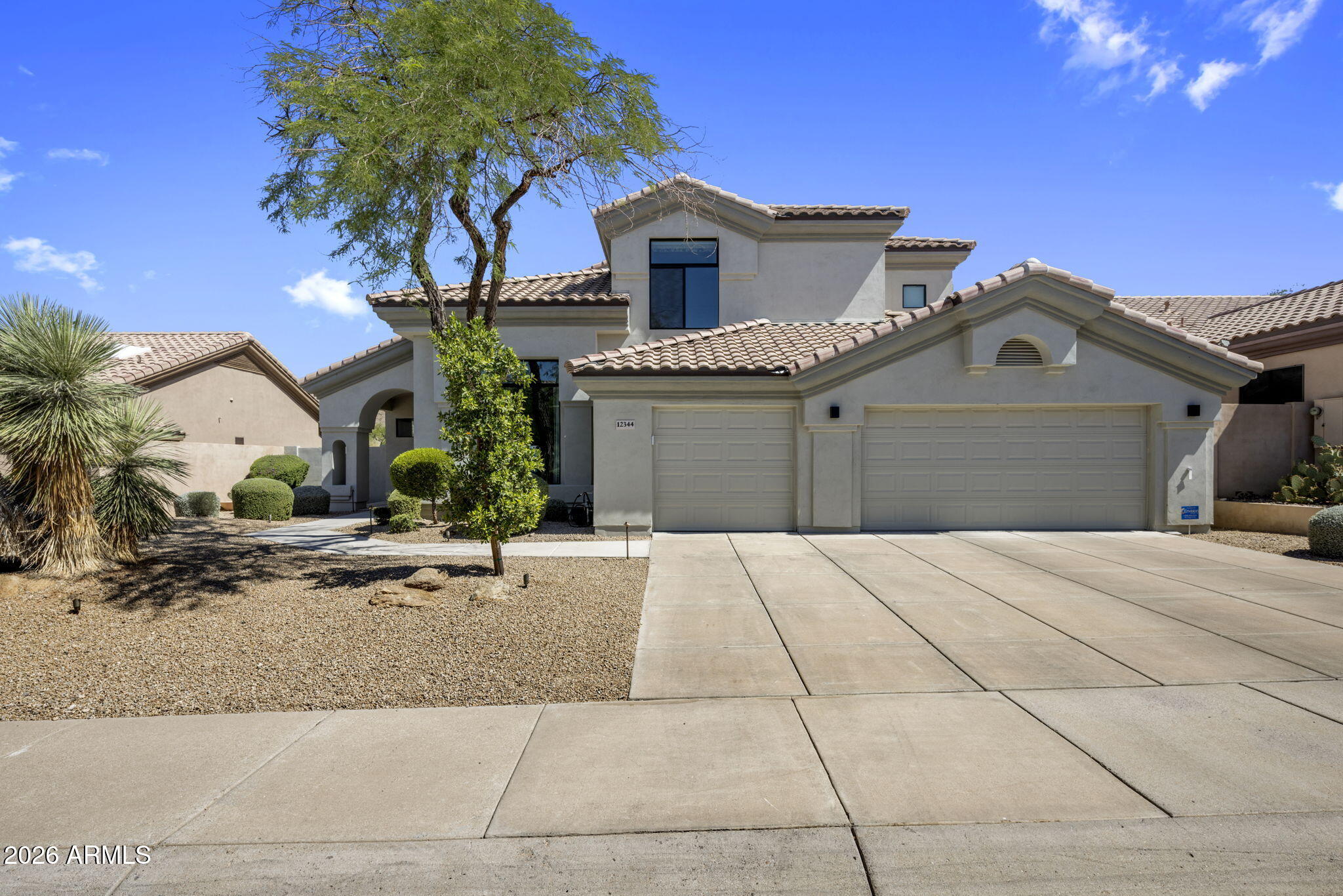 Designed with a polished modern feel and an easy sense of livability, this 4-bedroom plus den Scottsdale residence offers 3,516 square feet, 3.5 bathrooms, and thoughtful details throughout. Natural light fills the home, highlighting white oak hardwood floors, clean modern finishes, and an open layout that connects the main living spaces with ease. A full wall of paneled glass brings character and light into the office, while the two-story fireplace creates a strong focal point in the family room. The kitchen feels elevated without being overdone, with Calacatta quartz counters, fluted banco seating, frameless natural wood cabinetry, and premium appliances. The floor plan offers excellent flexibility, with two ensuite bedrooms on each level, making it ideal for guests, work-from-home needs or multi-generational living. Spa-inspired bathrooms and a resort-style pool complete the home, all in a convenient Scottsdale location close to both the elementary school and high school.