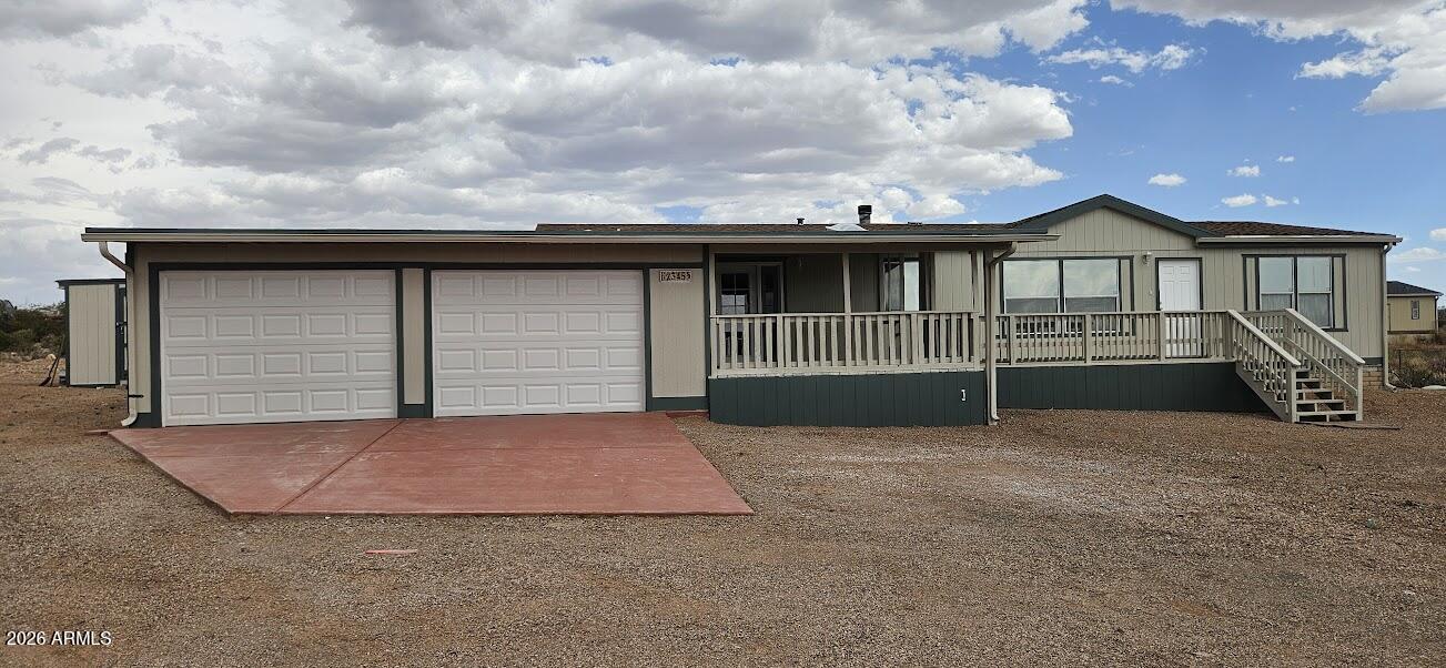 Nicely remodeled 3 bedroom, 2 bath manufactured home with a 2 car garage and detached storage building.  New roof, hvac, flooring, and kitchen.  The interior has a nice floorplan with split bedrooms, fireplace in the great room, and a buillt in work are for computer.  The kitchen has been remodeled with new cabinets, granite, and it has a island.  Very nice views of the mountain for a large deck  that has a portion of it screened in.