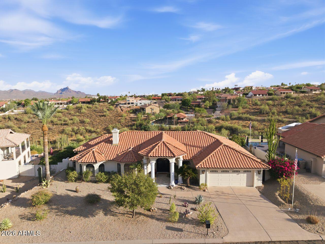 Spectacular views stretch for miles from this beautiful custom single-level home, where indoor-outdoor living is elevated to an art form. The expansive backyard terrace feels like a natural extension of the interior, overlooking a serene desert wash that creates a peaceful and private retreat. Relax and entertain while enjoying a sparkling swimming pool and spa, a spacious covered patio with tiled flooring, and breathtaking panoramic views of the Superstition Mountains, Four Peaks, and the iconic Fountain Hills Fountain. The completely updated kitchen is a chef's delight, featuring premium Bosch appliances, abundant cabinetry, quartz countertops, modern finishes, generous workspace, and a convenient prep sink. Elegant ceramic tile flooring flows throughout the home, enhancing both style and durability.

Additional highlights include a newer roof, NuVo Citrus whole-house water conditioning system, energy-efficient LED lighting throughout, and a spacious laundry room complete with a utility sink.

Offering a perfect blend of comfort, quality, and unforgettable scenery, this exceptional home is a rare opportunity you won't want to miss.