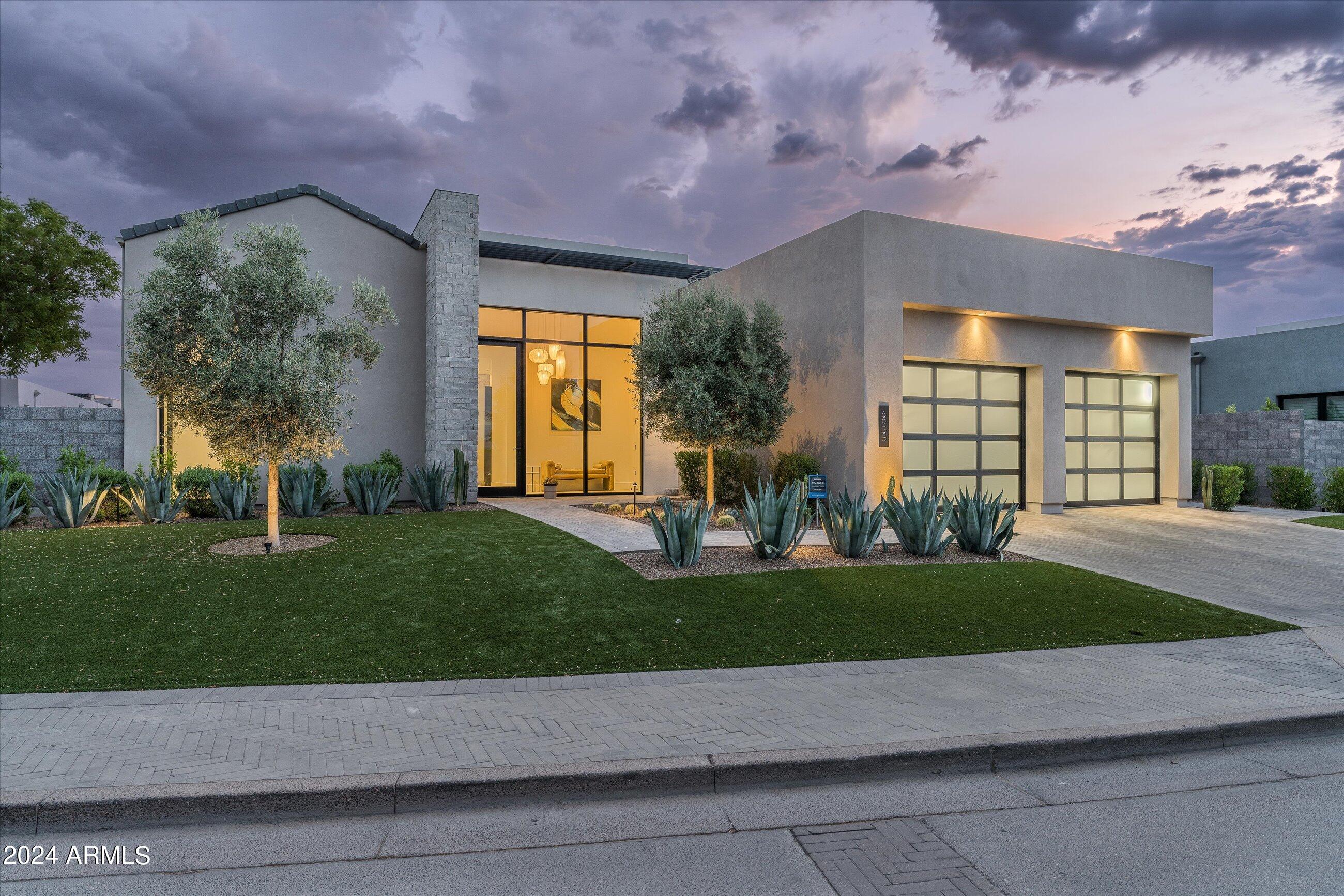 Recently completed & highly appointed contemporary home in Azure...the Ritz Carlton-adjacent enclave in the heart of Paradise Valley. Positioned on a quiet & private interior corner lot w/ peeks of both Camelback & Mummy Mountains, this property offers the right size for a lock 'n leave lifestyle. Finishes include Oak floors, Western doors & windows, ebonized rift-cut Oak cabinetry, natural Quartzite counters, Gaggenau appliances, motorized shades, custom Venetian-plastered & tiled fireplace surround, Limestone accent walls, Lutron lighting system & discreet flush-mounted surround sound speakers. The lushly landscaped rear yard includes a pool, water feature, outdoor kitchen & cantilevered fire feature. Walk to the Ritz-Carlton & the future exclusive world-class Palmeraie shopping centre.