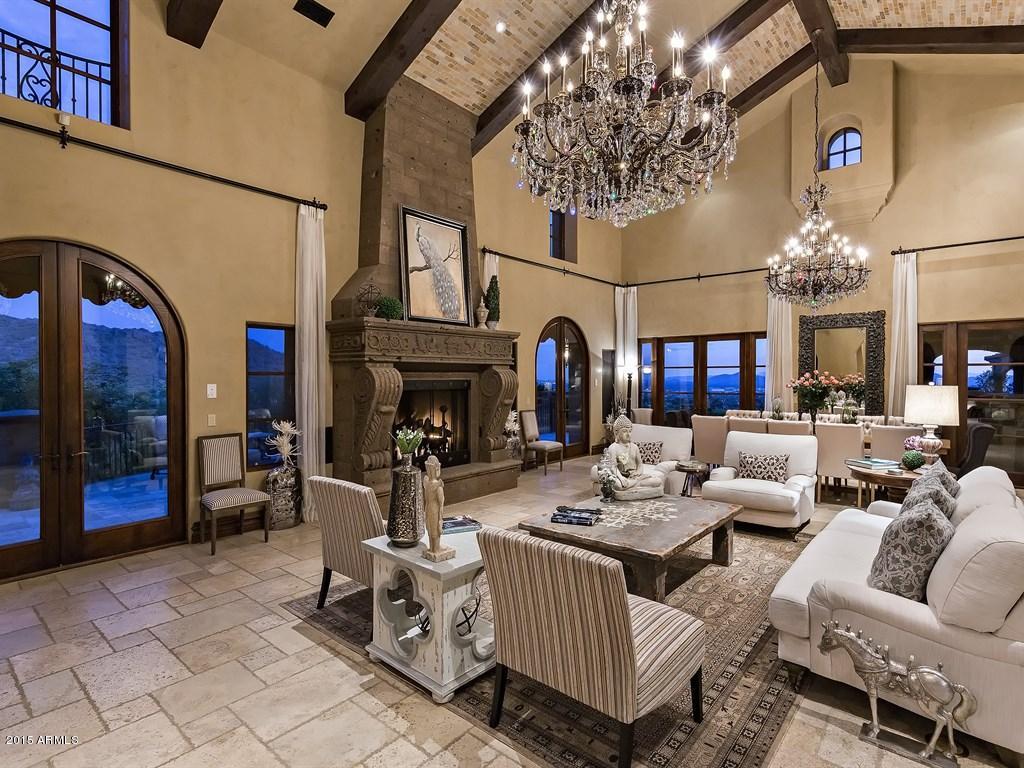 This exquisite masterpiece is consumed with elegance and is nestled on a dramatic 8 acre hillside lot with magnificent endless views from every window. Spacious but cozy home consists of Master, Movie, Office, Formal Living, Gourmet Kitchen and Family all on the ground level. 4 large bedrooms in main house and a completely fully contained guest house with full kitchen await your guests. This home has been professionally decorated and offers a refreshing atmosphere. Many patios with fireplaces are situated around this private estate. The craftsmanship and details in this home are top notch.Perfect home for entertaining with pocket doors leading you to a  huge patio overlooking the exclusive golf course. A charming circular driveway with double gates and six car garage completes this home.